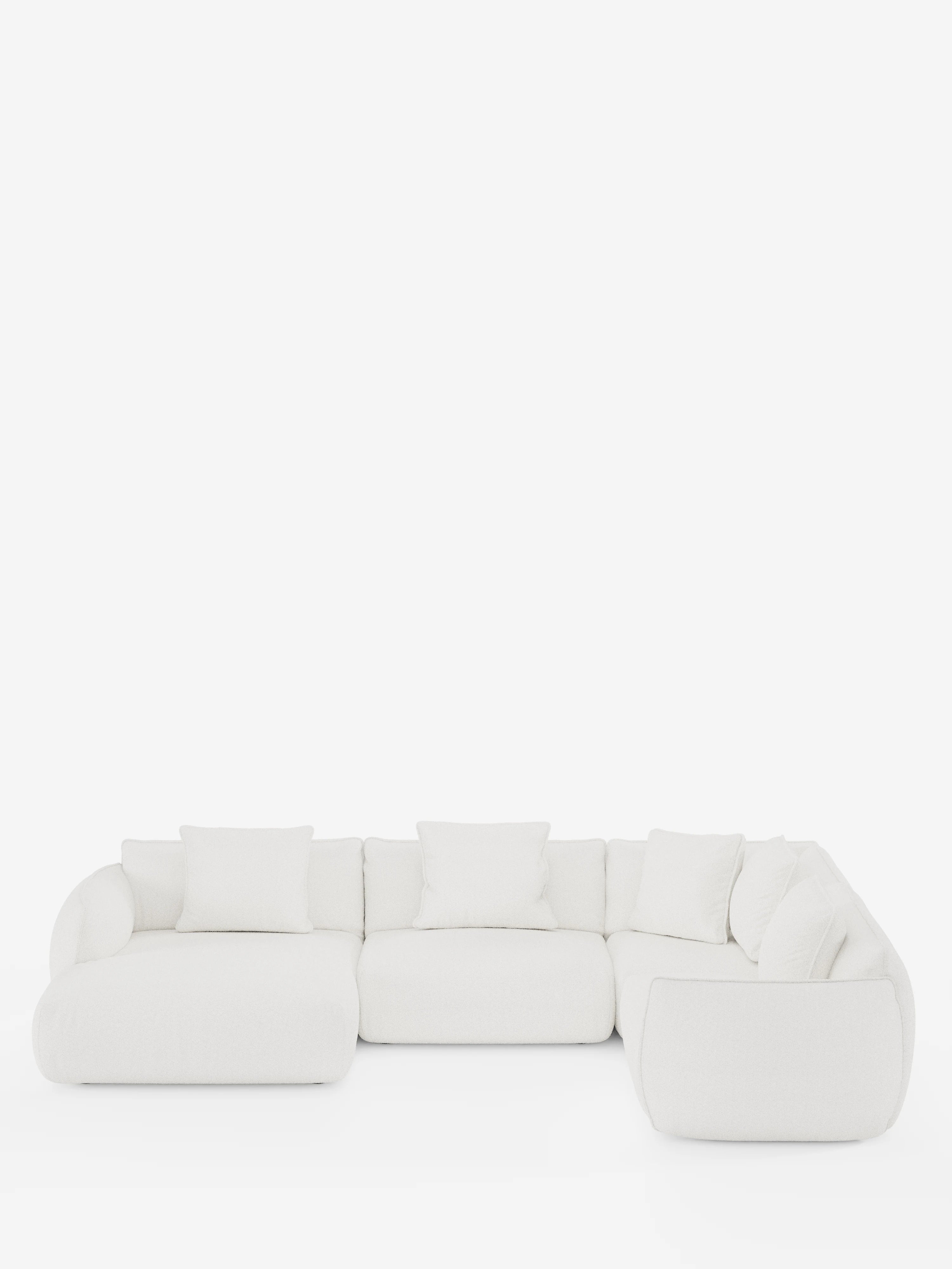 Un divano angolare panoramico componibile Nimbus in stile contemporaneo, bianco, con penisola e angolo in tessuto smacchiabile T33 di Divani.Store, caratterizzato da bordi arrotondati e morbidi cuscini disposti a forma di L su uno sfondo bianco a tinta unita. Questo elegante divano componibile vanta cinque cuscini dello schienale e linee morbide e minimaliste, che creano un’atmosfera accogliente e invitante.