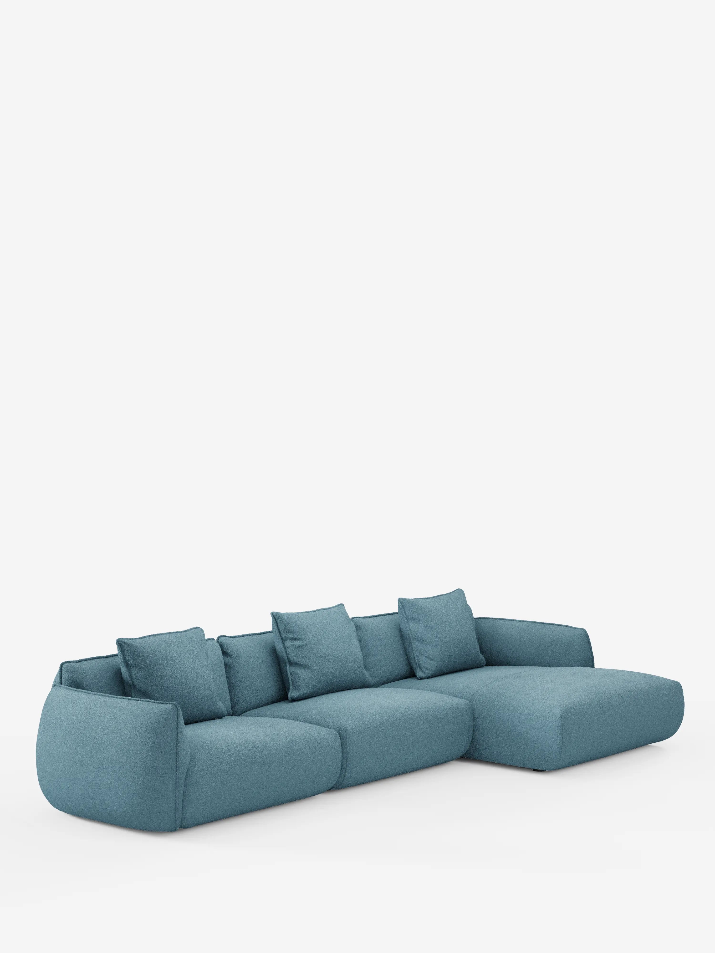 Il divano angolare con penisola componibile Nimbus in morbido tessuto effetto cotone smacchiabile T33 di Divani.Store è un moderno divano componibile color verde acqua con chaise longue a destra, cinque cuscini coordinati, morbidi bordi arrotondati e uno schienale basso, il tutto su uno sfondo bianco a tinta unita.