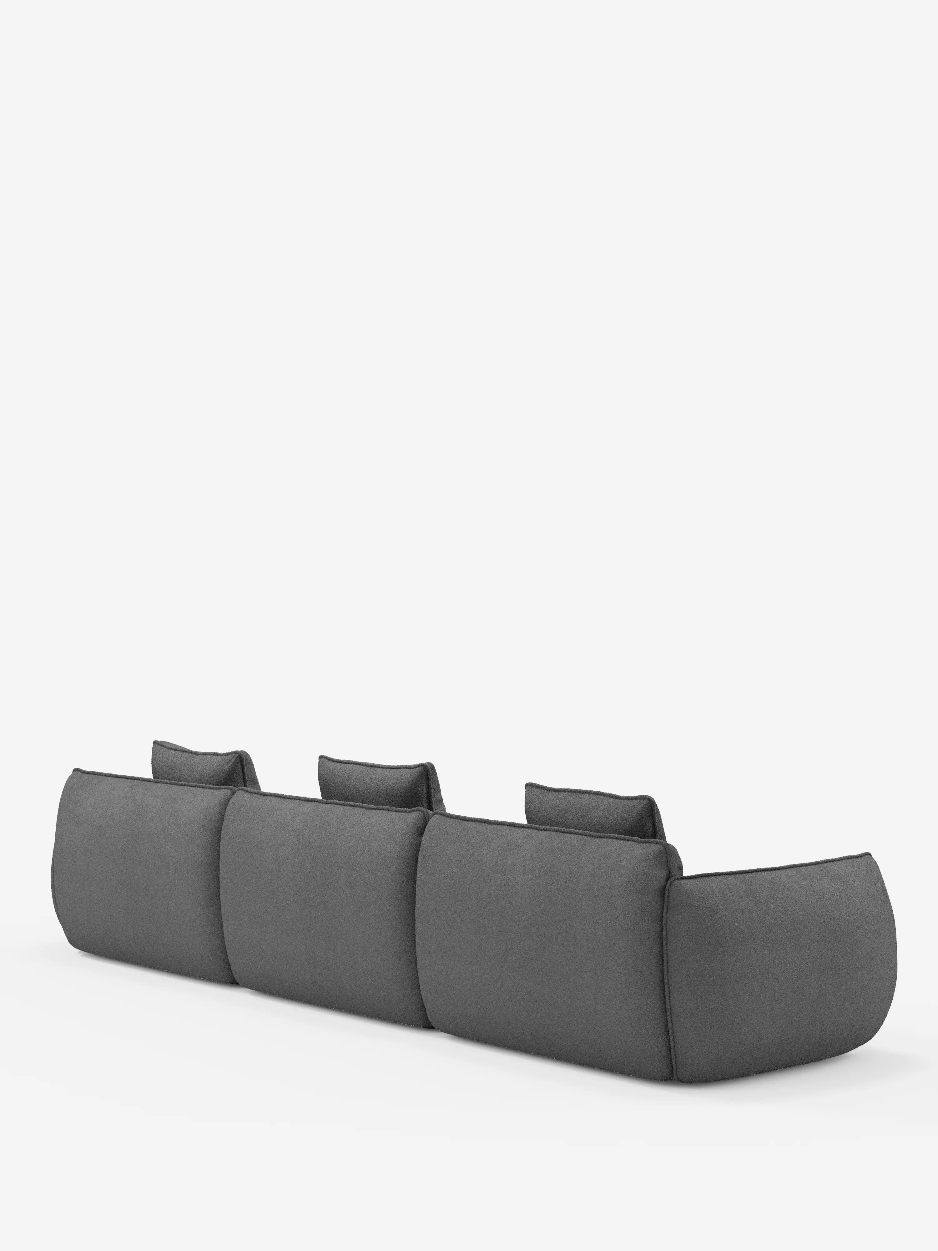Il divano angolare Nimbus di Divani.Store con penisola componibile in morbido tessuto effetto cotone smacchiabile T33 è ripreso da dietro in un’angolazione che ne esalta il design minimalista in grigio scuro. I morbidi cuscini squadrati si fondono armoniosamente con i braccioli bassi e leggermente arrotondati. Sullo sfondo bianco uniforme, la scena accentua l’estetica moderna e raffinata di questo divano componibile contemporaneo.