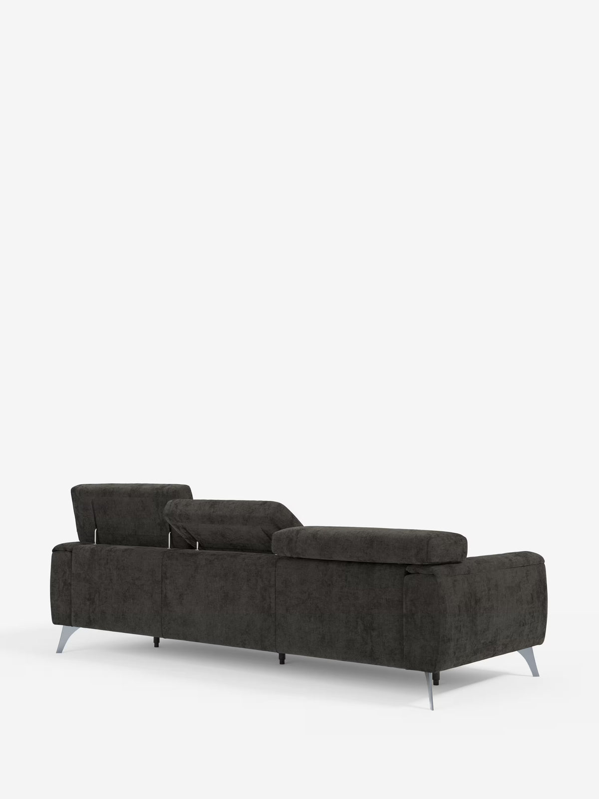 Un divano Caravaggio a 4 posti con tre sedute scorrevoli di Divani.Store, color grigio antracite scuro, con gambe in metallo, è ripreso da dietro e leggermente di profilo. Questo elegante divano presenta poggiatesta reclinabili, linee pulite e dritte e un rivestimento in tessuto T31 antimacchia, in risalto su uno sfondo bianco a tinta unita.