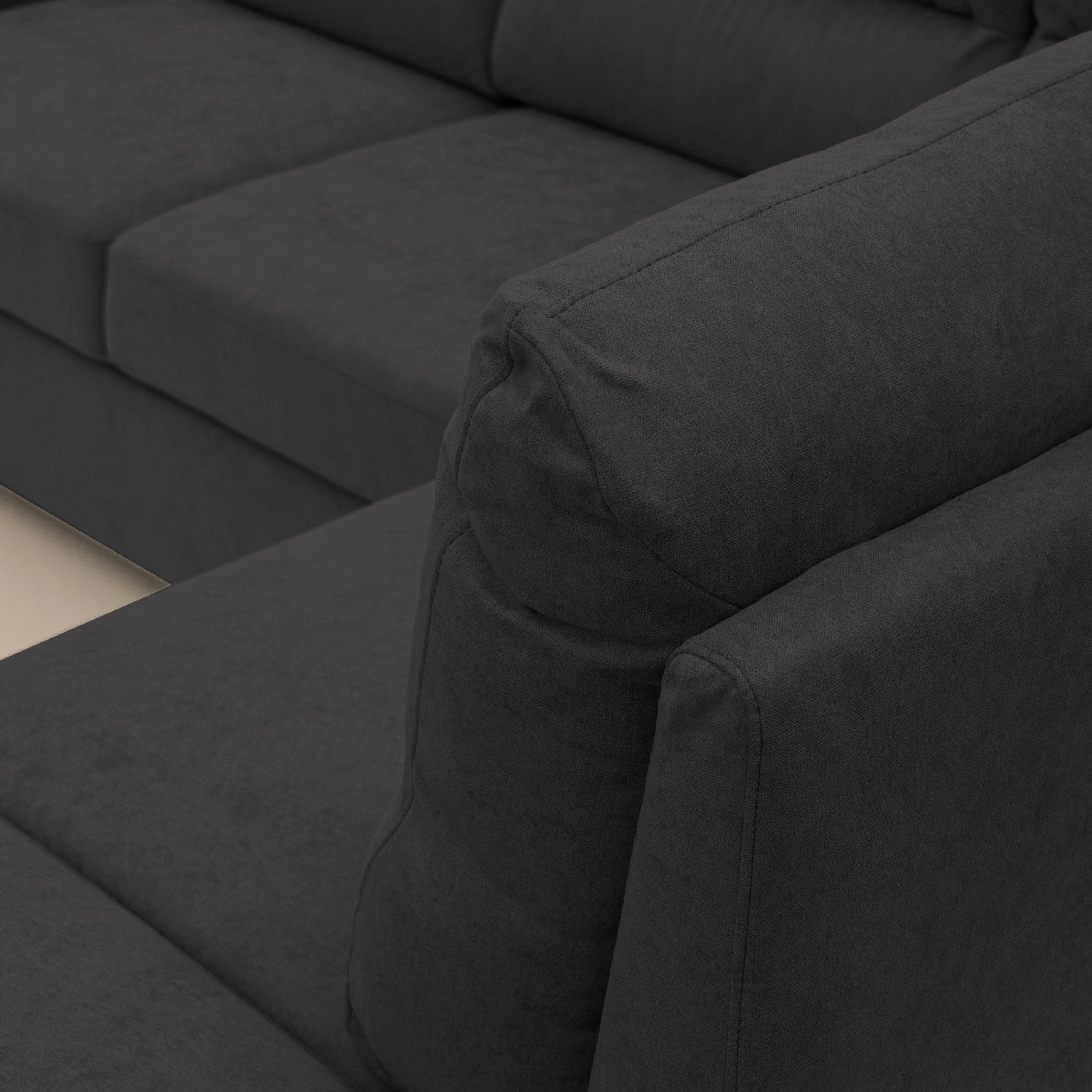 Minerva divano angolare con estraibile a cassettone e pouf contenitore in tessuto morbido impermeabile T02 nero - divani.store