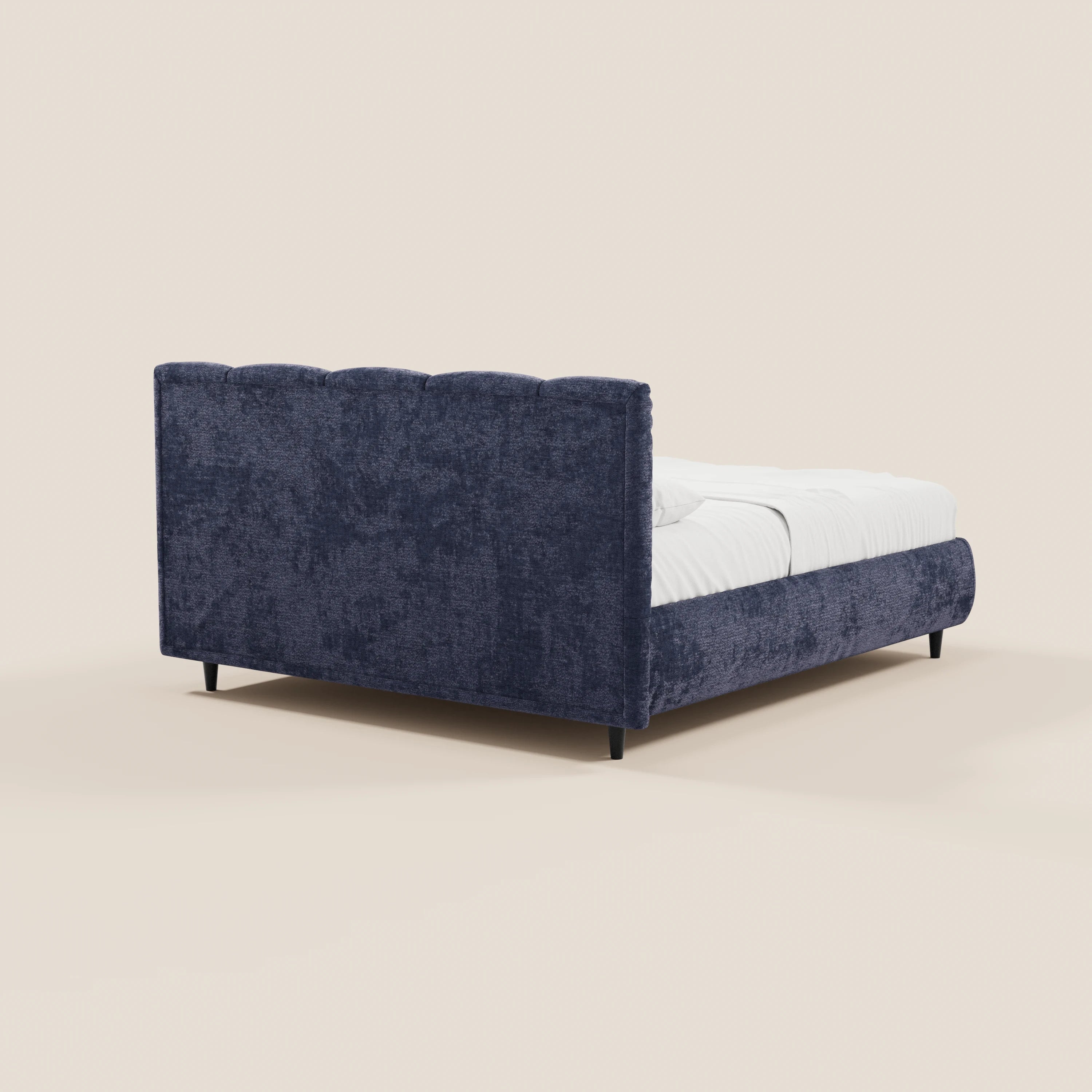 Il letto imbottito ARKAM di Letti.store, realizzato in tessuto Oeko-Tex®, è dotato di vano contenitore, testiera alta con lavorazione verticale in stile shabby chic e gambe nere. Presentato con biancheria da letto bianca su sfondo beige chiaro per un look moderno.