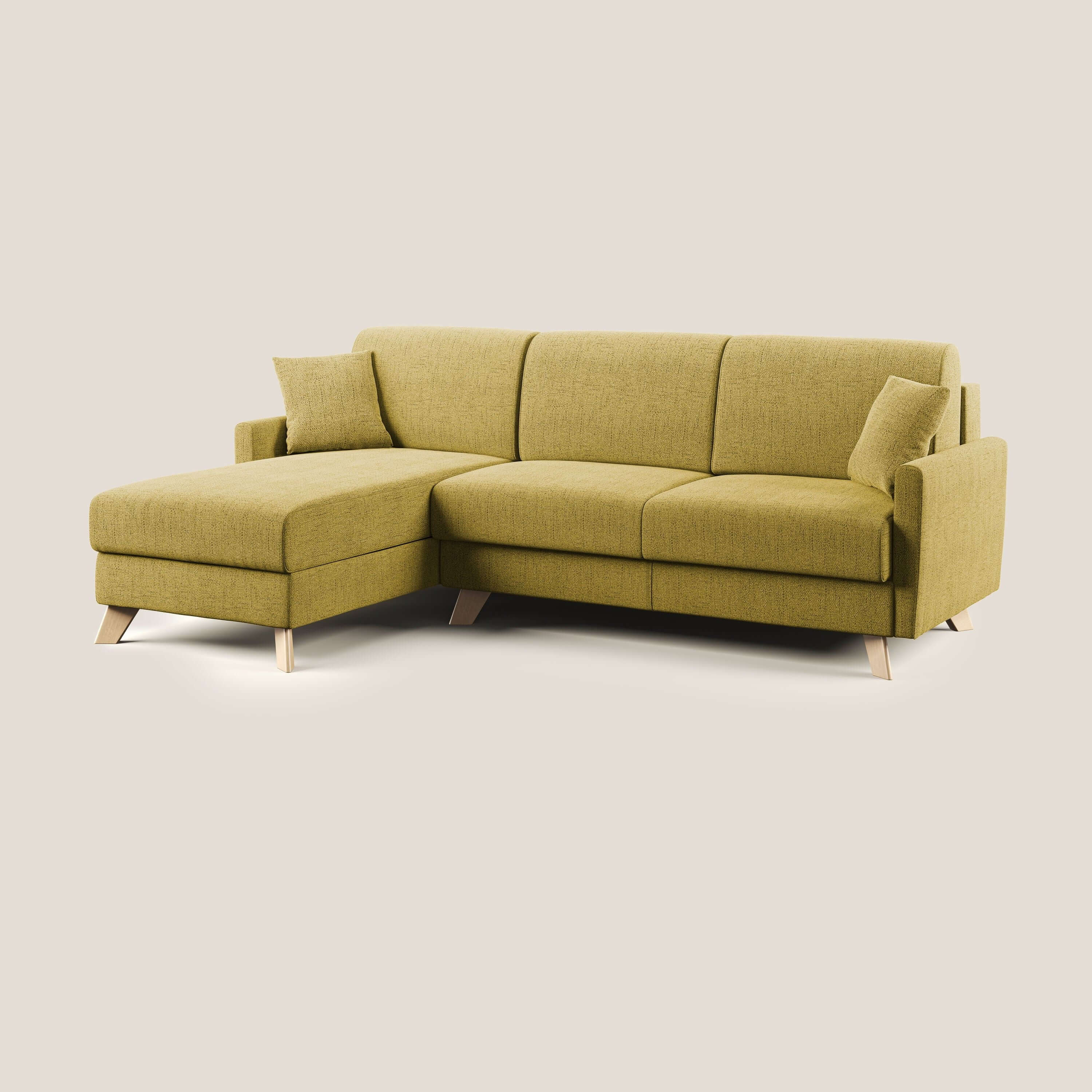 Il divano letto angolare Edgar 243 cm sinistro di Divani.Store, in tessuto impermeabile felis T03 giallo, è caratterizzato da una chaise longue sinistra, gambe in legno, due cuscini coordinati e RETE A DOGHE; su uno sfondo beige tinta unita.