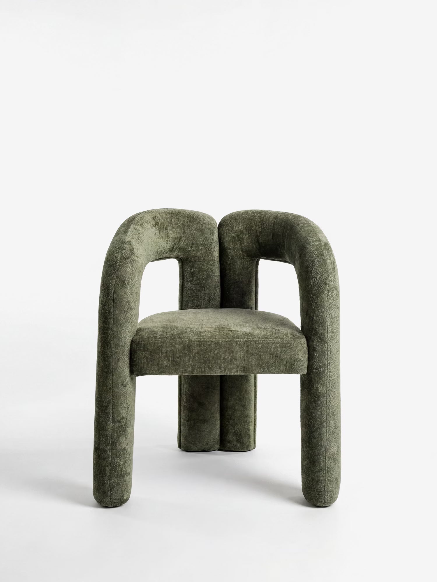 La Sibilla, sedia di design imbottita di Divani.Store, presenta gambe e braccioli spessi e arrotondati, interamente rivestita in tessuto testurizzato verde oliva con una forma arcuata e scultorea, e seduta e schienale morbidi su uno sfondo bianco a tinta unita.