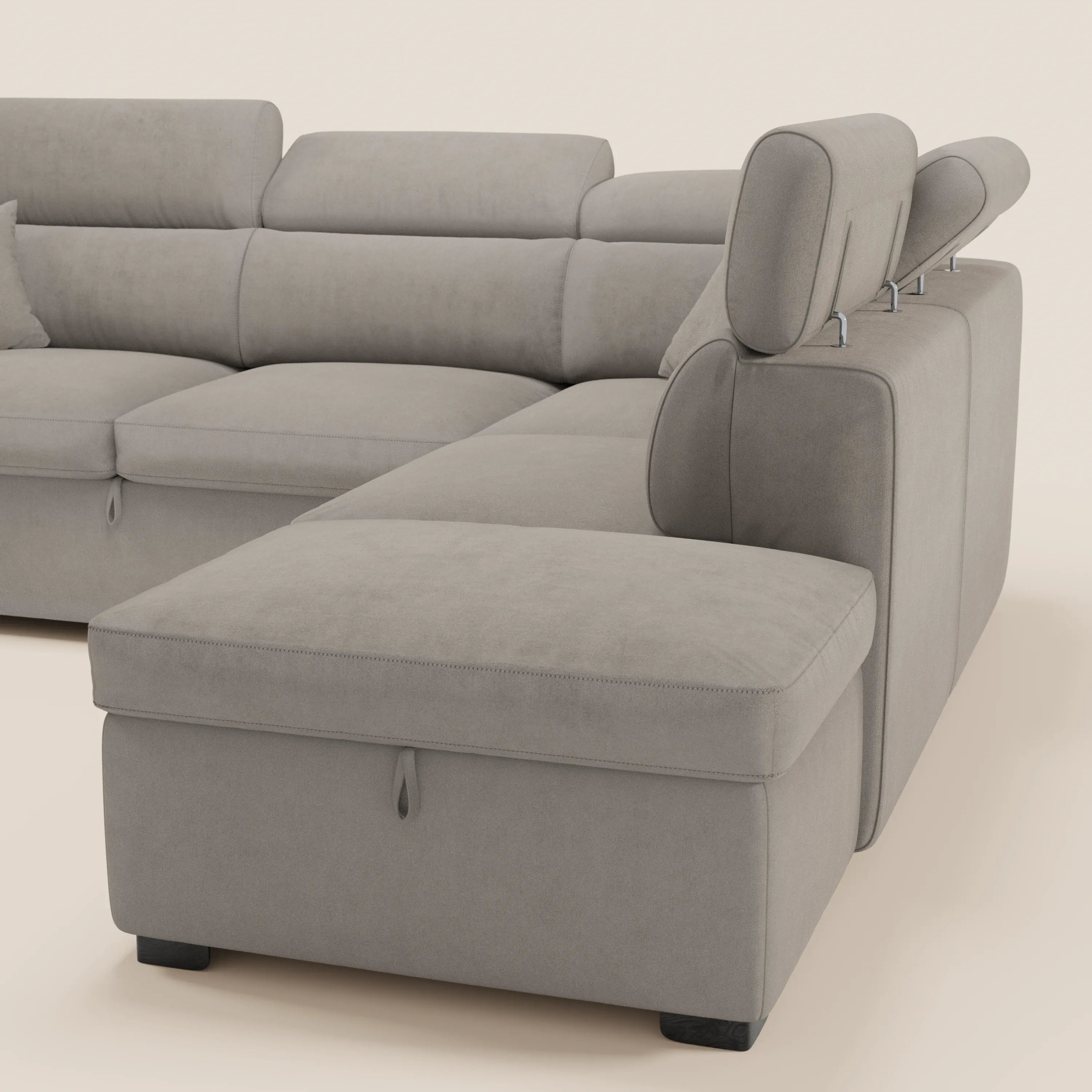 Il divano angolare reversibile Titano di Divani.Store è dotato di poggiatesta reclinabili, una chaise longue, una sezione estraibile e un pouf contenitore. Rivestito in morbido tessuto grigio chiaro certificato Oeko-Tex® con cuciture a vista e gambe corte nere.