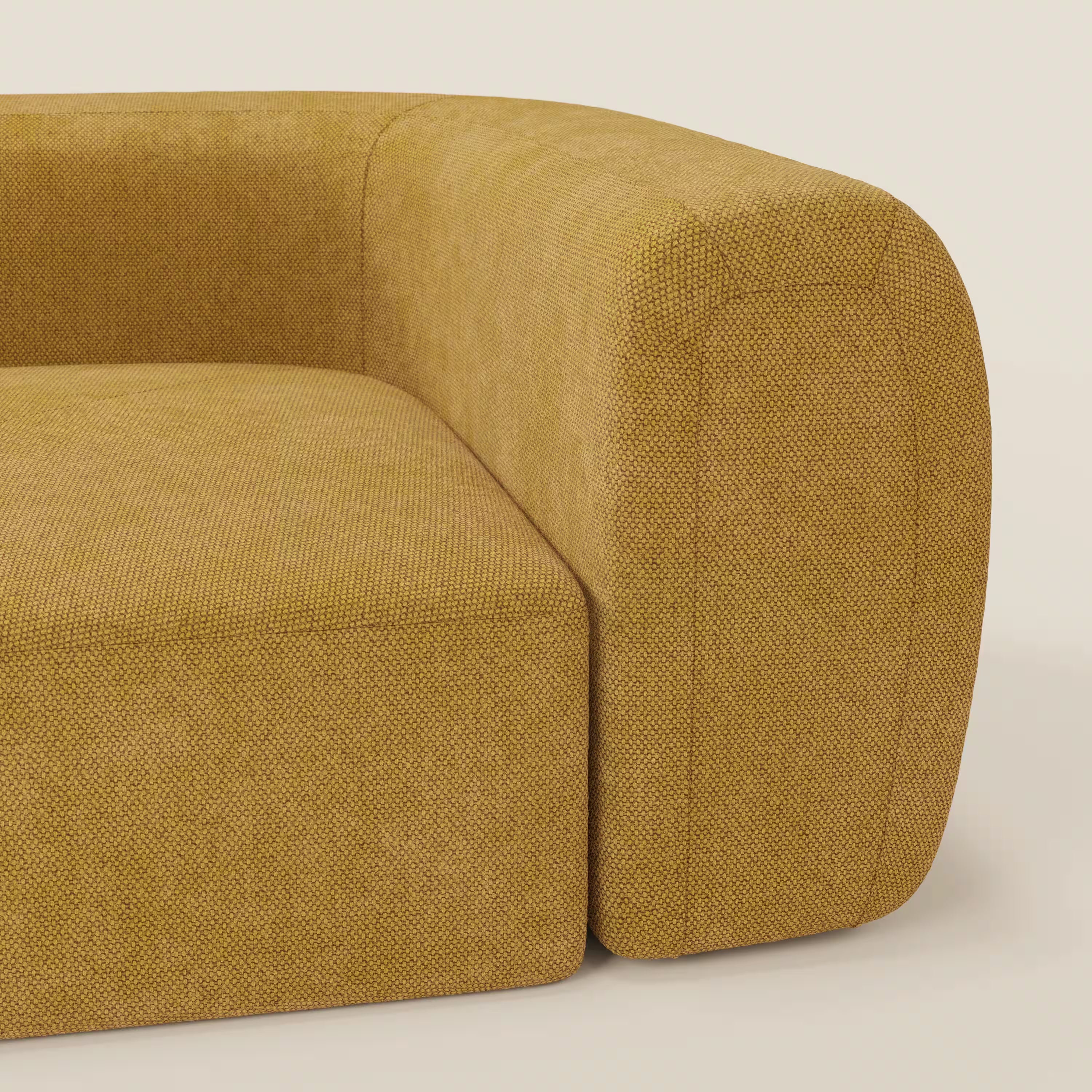 Primo piano del BonBon Modulo angolare - Divano componibile GF edition giallo di Divani.Store, che mette in evidenza il tessuto strutturato giallo senape, il bracciolo arrotondato, il cuscino di seduta e le linee curve morbide e minimaliste.