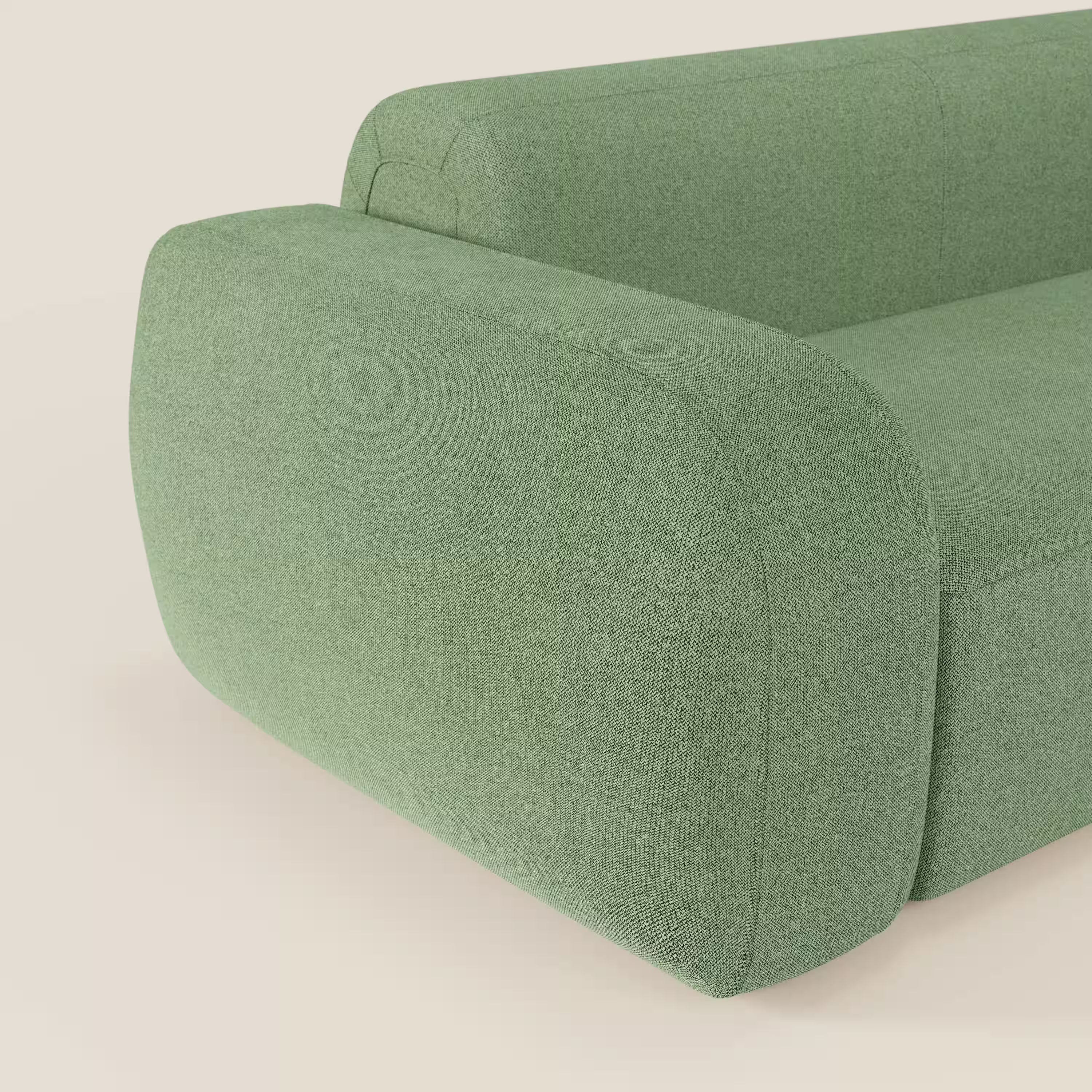 Primo piano del BonBon Divano modulare Lineare 220 di Divani.Store, presentato in tessuto smacchiabile T23 menta. Il design è caratterizzato da ampi braccioli e linee minimaliste, con solo una parte della seduta unica visibile su uno sfondo neutro.