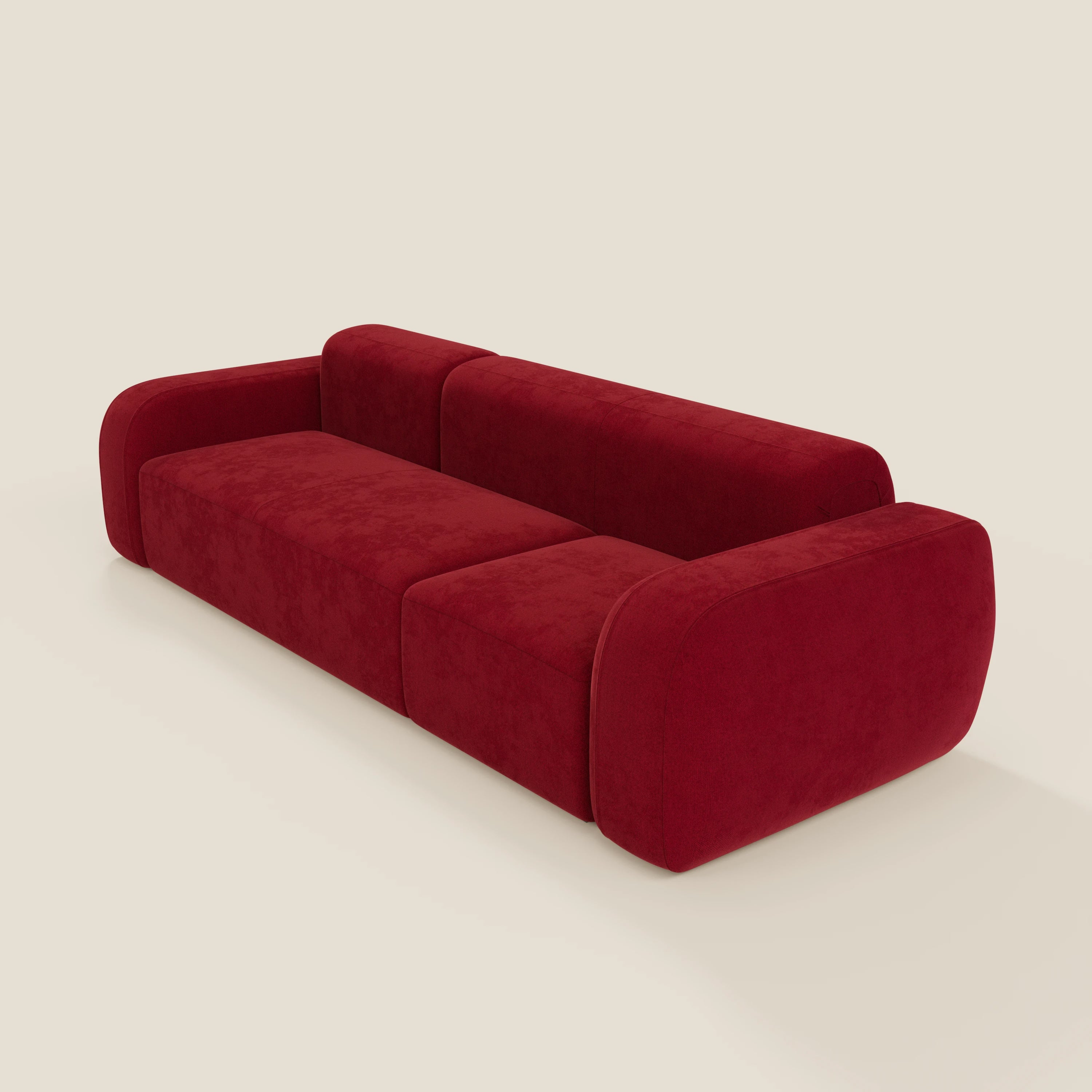 Il BonBon Divano componibile - Composizione Spaccamattone in tessuto smacchiabile T23 bordeaux di Divani.Store è caratterizzato da un design moderno e minimalista con bordi arrotondati e sedute morbide, su uno sfondo beige semplice per un look unico e contemporaneo.