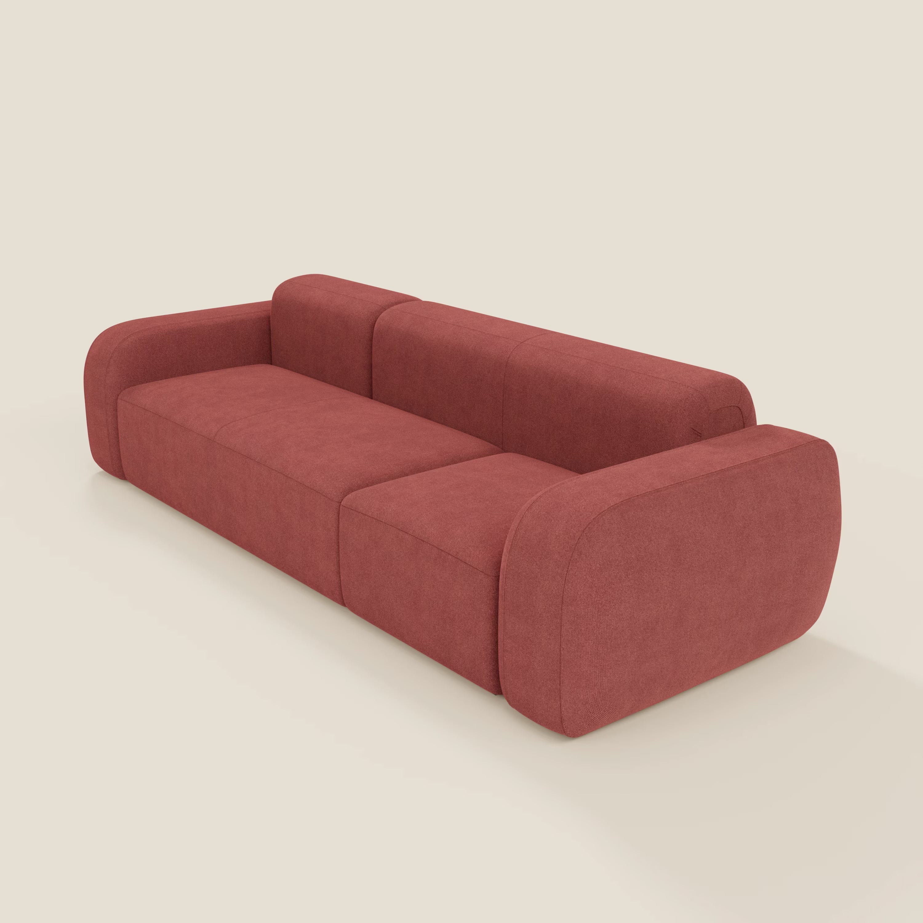 Il BonBon Divano componibile - Composizione Spaccamattone in tessuto smacchiabile T23 rosso ciliegia di Divani.Store è caratterizzato da un design moderno e minimalista con ampi braccioli, cuscini spessi e tessuto accogliente su sfondo beige chiaro.