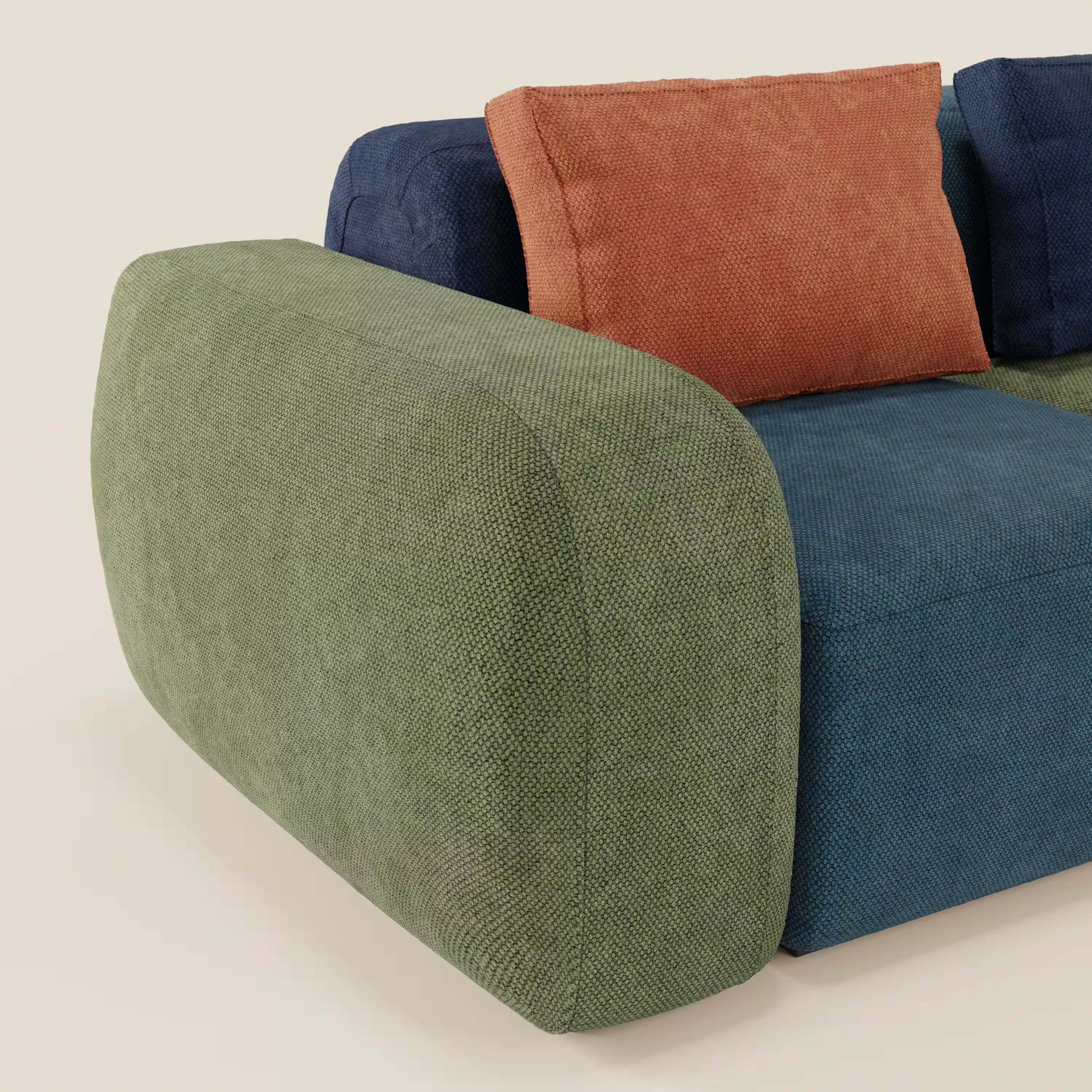 Il BonBon Grande Fratello Edition di Divani.Store è un divano modulare moderno con bordi arrotondati, bracciolo verde, seduta blu e cuscino arancione su una base beige. Il suo rivestimento ha un aspetto intrecciato e un caratteristico disegno patchwork.