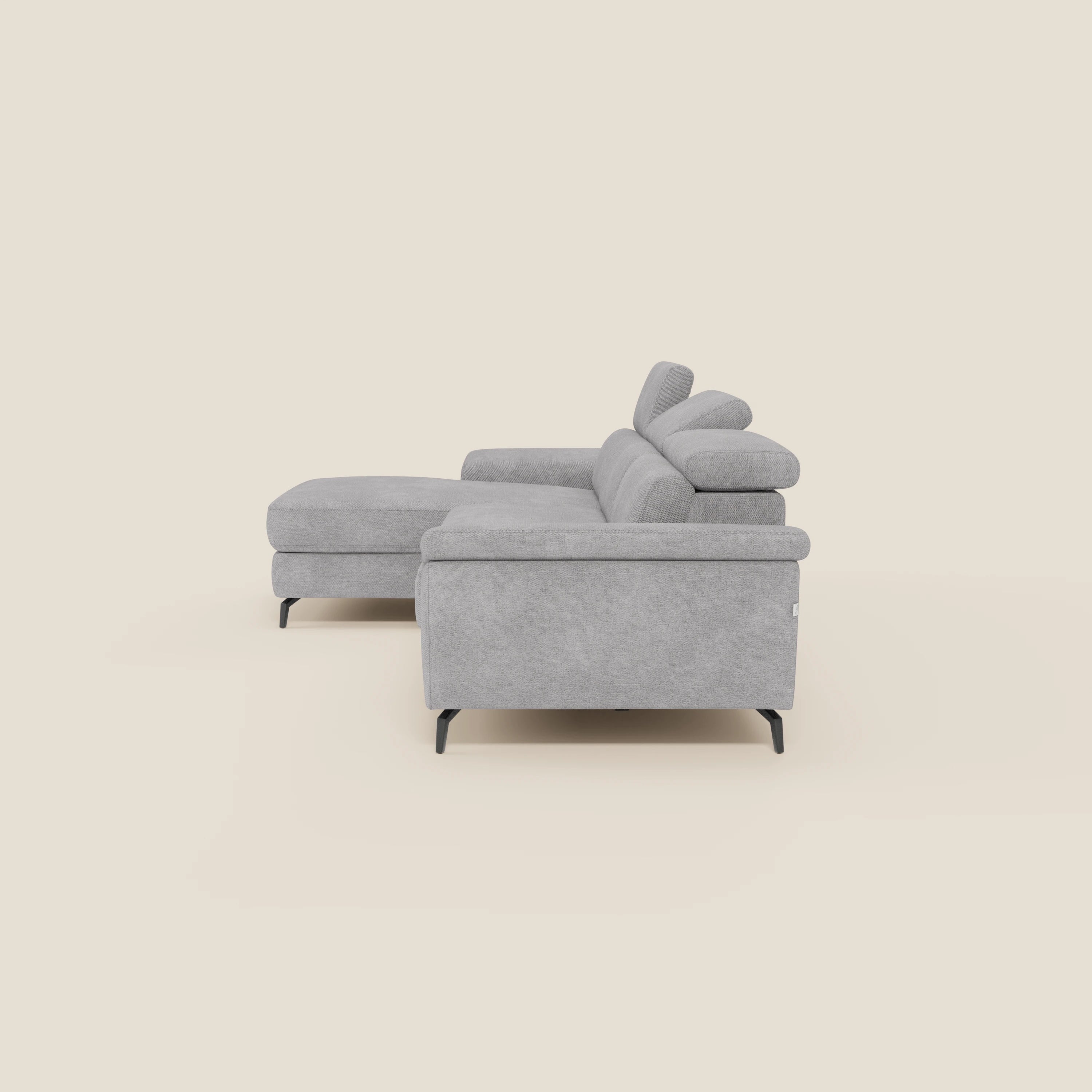 Estro Divano estraibile di Divani.Store in tessuto impermeabile grigio chiaro T14 è dotato di chaise-longue sinistra, poggiatesta regolabili e sottili gambe in metallo nero. Presentato affiancato su uno sfondo crema con cuscini lisci e minimalisti.