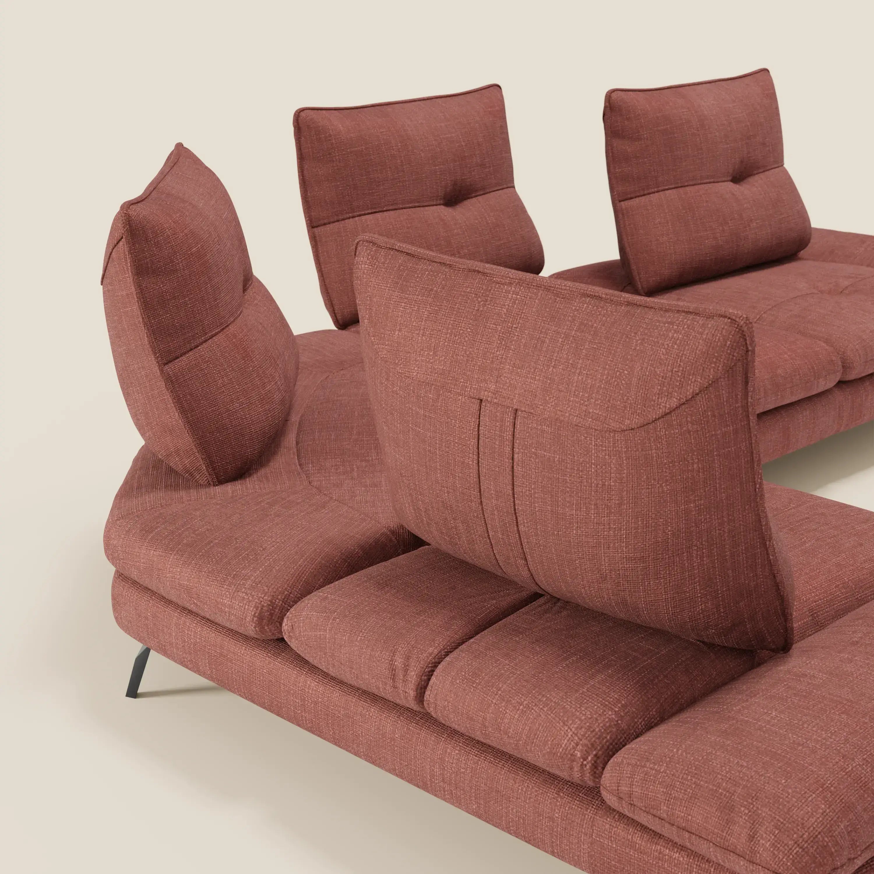 Ardex Divano Angolare di Divani.Store è caratterizzato da schienali traslanti, bracciolo regolabile ed elegante tessuto impermeabile T06 corallo con sottili gambe in metallo nero, su sfondo beige chiaro.