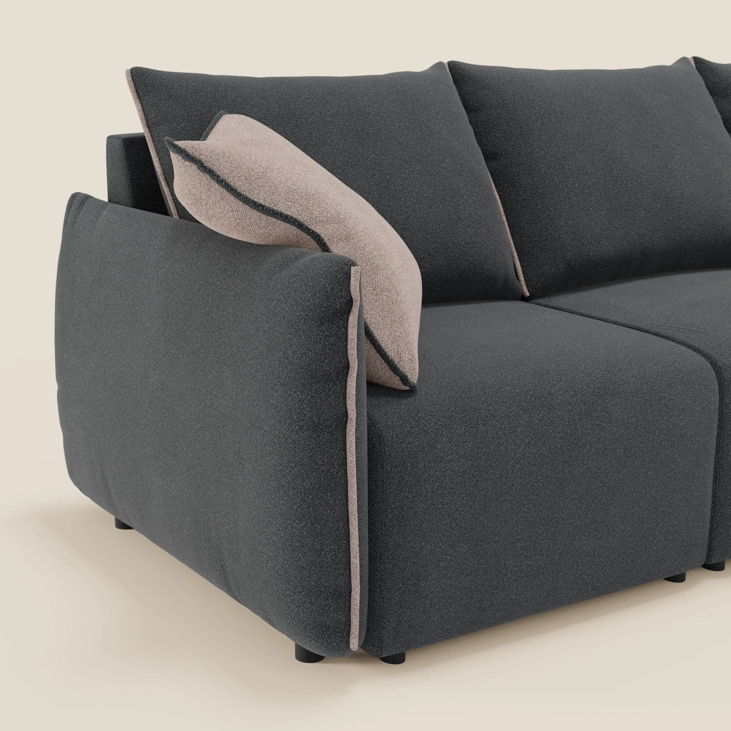 Il divano Flexar di Divani.Store è caratterizzato da 3 sedute allungabili, uno schienale in piuma e un bouclé impermeabile T07 color antracite. Ha bordi arrotondati, morbidi cuscini imbottiti, profili beige chiaro, gambe corte nere e si inserisce in un fondo tinta unita color crema.