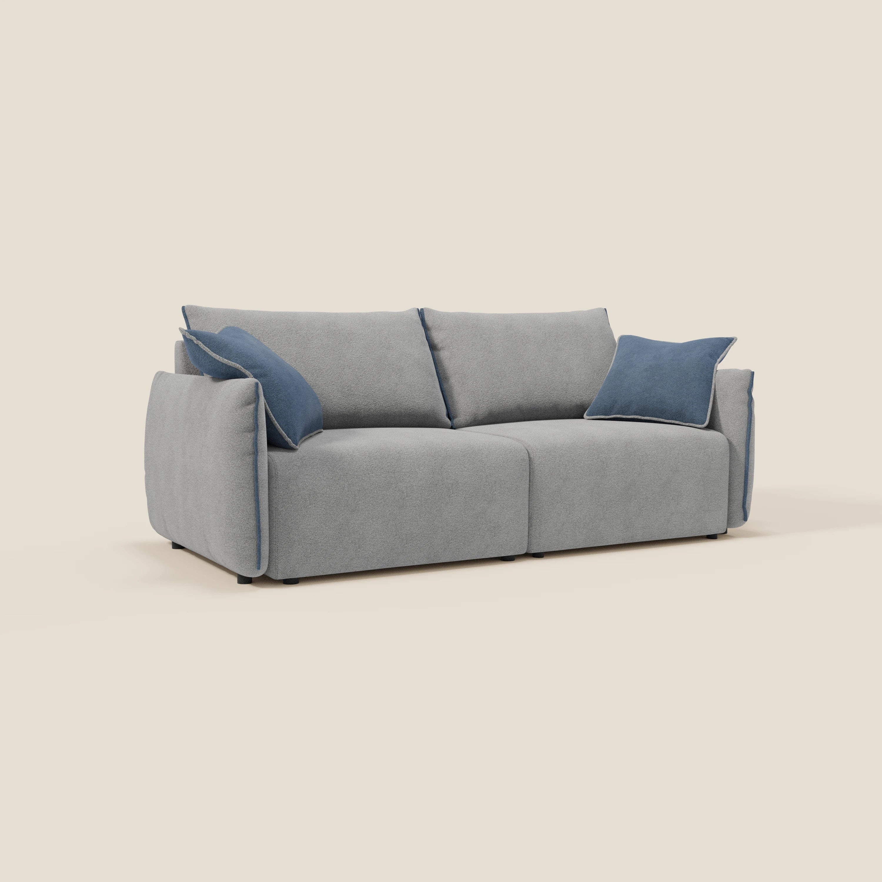 Il divano Flexar di Divani.Store è caratterizzato da sedute allungabili, schienali in piuma e morbido bouclé resistente all'acqua in grigio-blu T07. Due cuscini coordinati e cuscini blu a contrasto completano il look moderno con bordi arrotondati su sfondo beige.