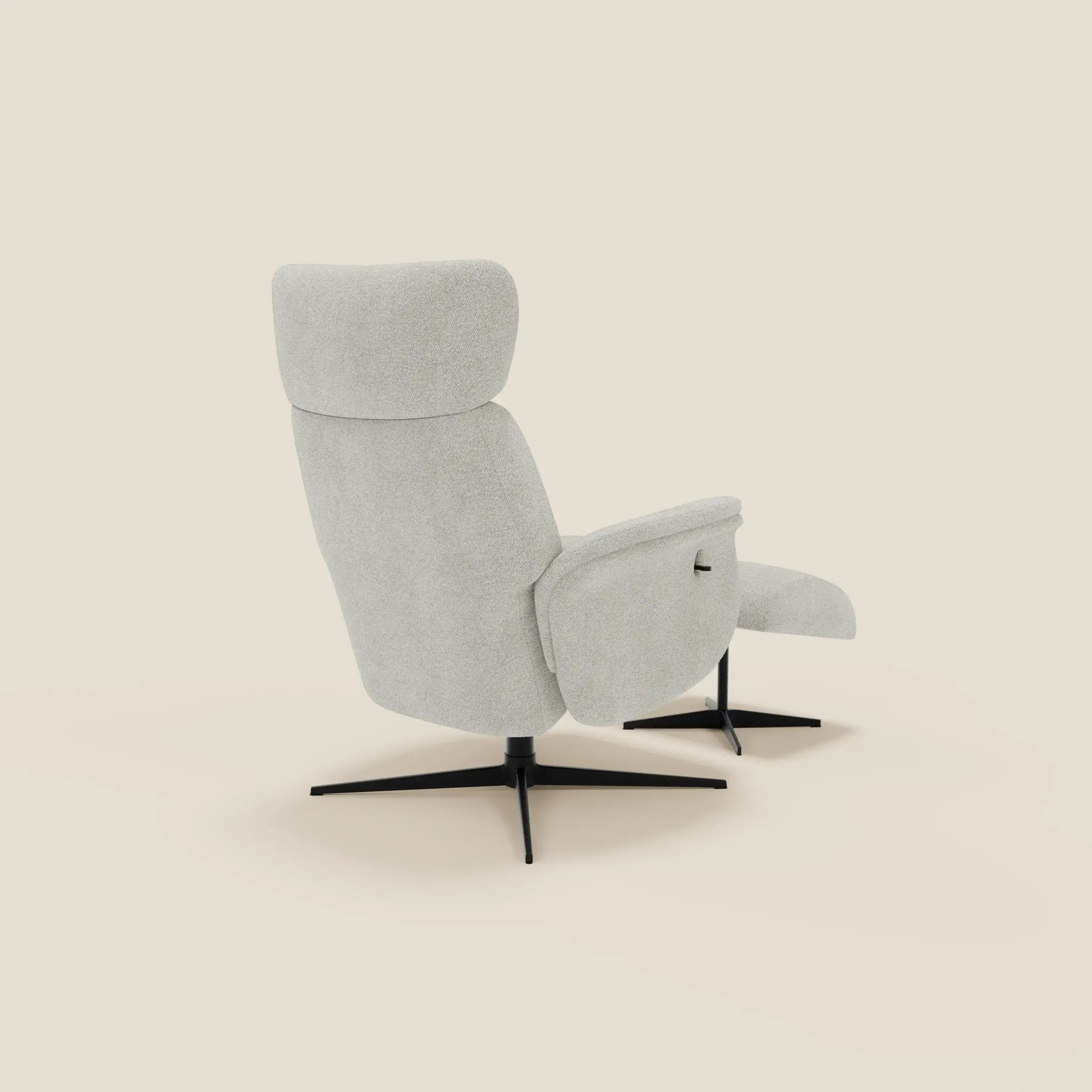 La poltrona relax reclinabile Lunor Poltrona di Divani.Store è caratterizzata da un tessuto bouclé bianco impermeabile, uno schienale alto, braccioli imbottiti, una base a quattro punte in metallo nero e viene fornita con un pouf poggia-piedi coordinato. Presentato reclinato su uno sfondo bianco sporco.