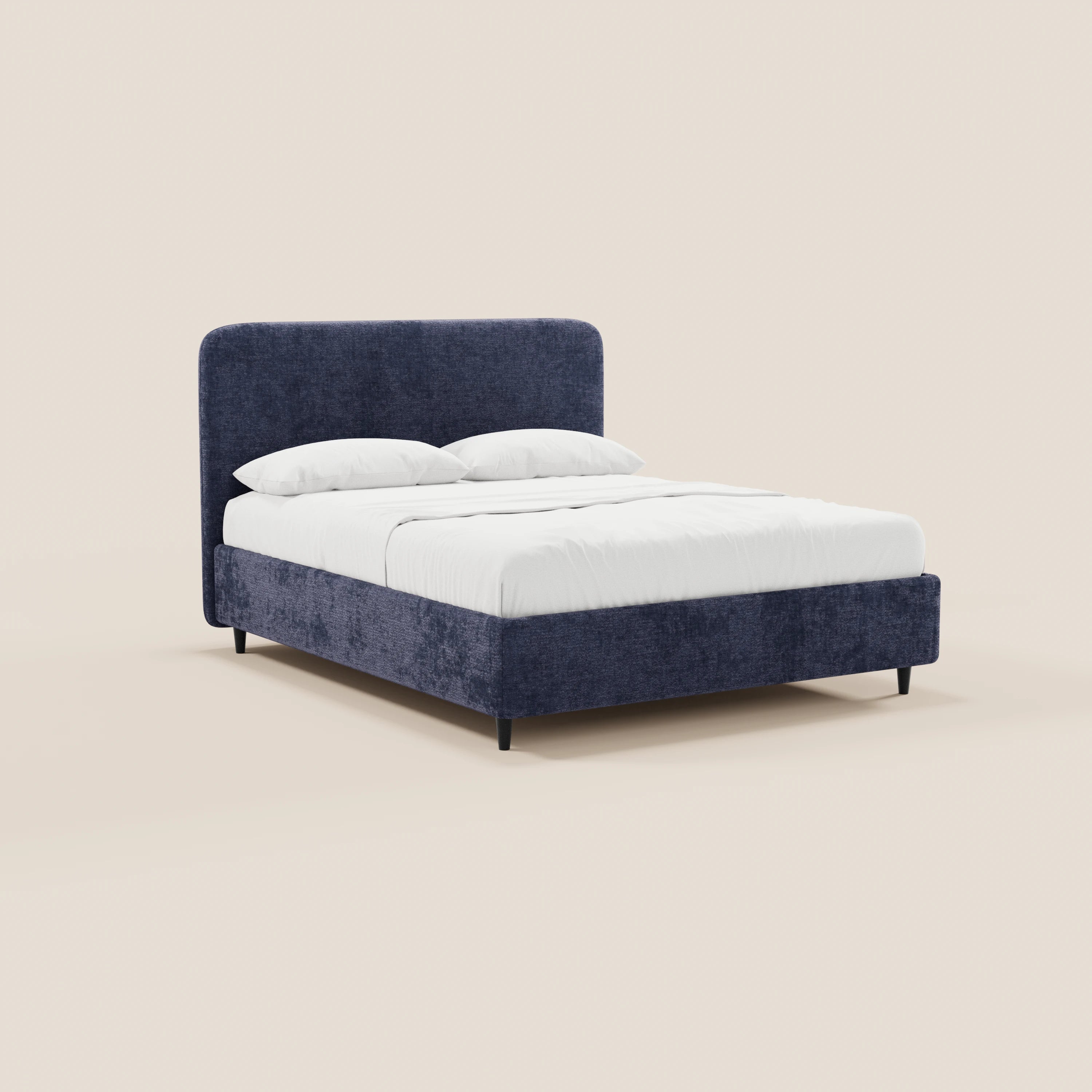 Il letto imbottito KAELOS minimal di Letti.store presenta una testiera e una struttura rivestite in ciniglia blu scuro, gambe alte nere, biancheria da letto bianca con due cuscini e un design minimalista, il tutto su uno sfondo beige chiaro.