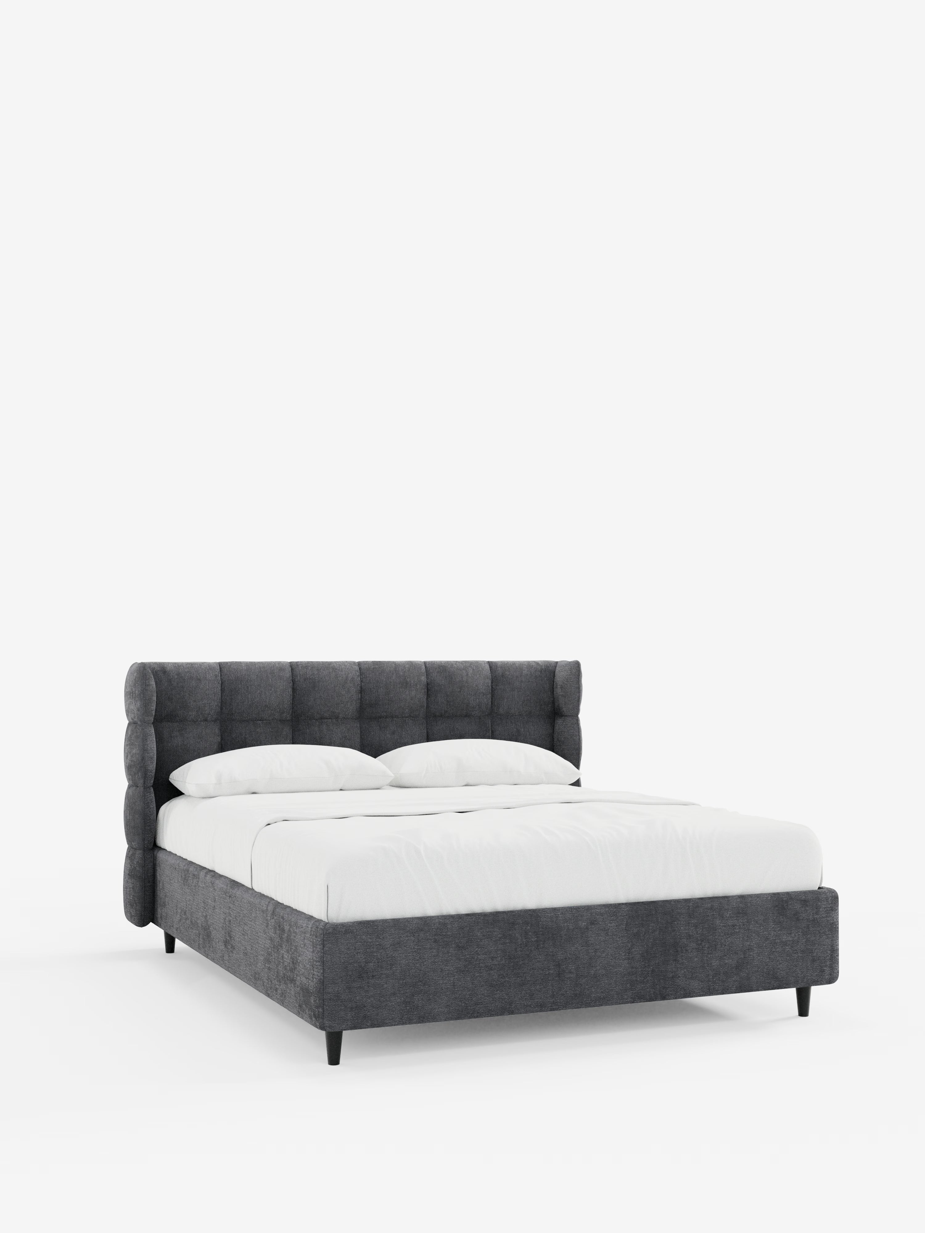 Il letto imbottito RAGNAR con contenitore e testiera capitonné avvolgente di Letti.store si caratterizza per un design moderno e dal profilo ribassato, con un’elegante testiera capitonné grigio scuro e una struttura in tessuto certificato Oeko-Tex®. Realizzato con cura, con biancheria da letto e cuscini bianchi e messo in risalto da uno sfondo bianco a tinta unita, questo raffinato letto contenitore poggia su corte gambe nere.