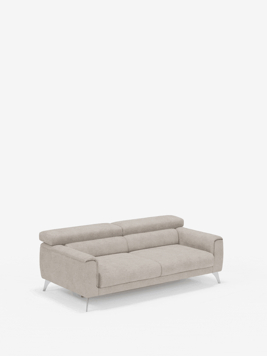 Un moderno divano a due posti Caravaggio di Divani.Store in beige chiaro, dotato di sedute allungabili e poggiatesta reclinabili in elegante tessuto smacchiabile T31, dalle linee pulite e con gambe cromate, è posizionato al centro di uno sfondo bianco a tinta unita. Il divano appare lussuoso e confortevole, con un design minimalista che si integra perfettamente in qualsiasi soggiorno contemporaneo.