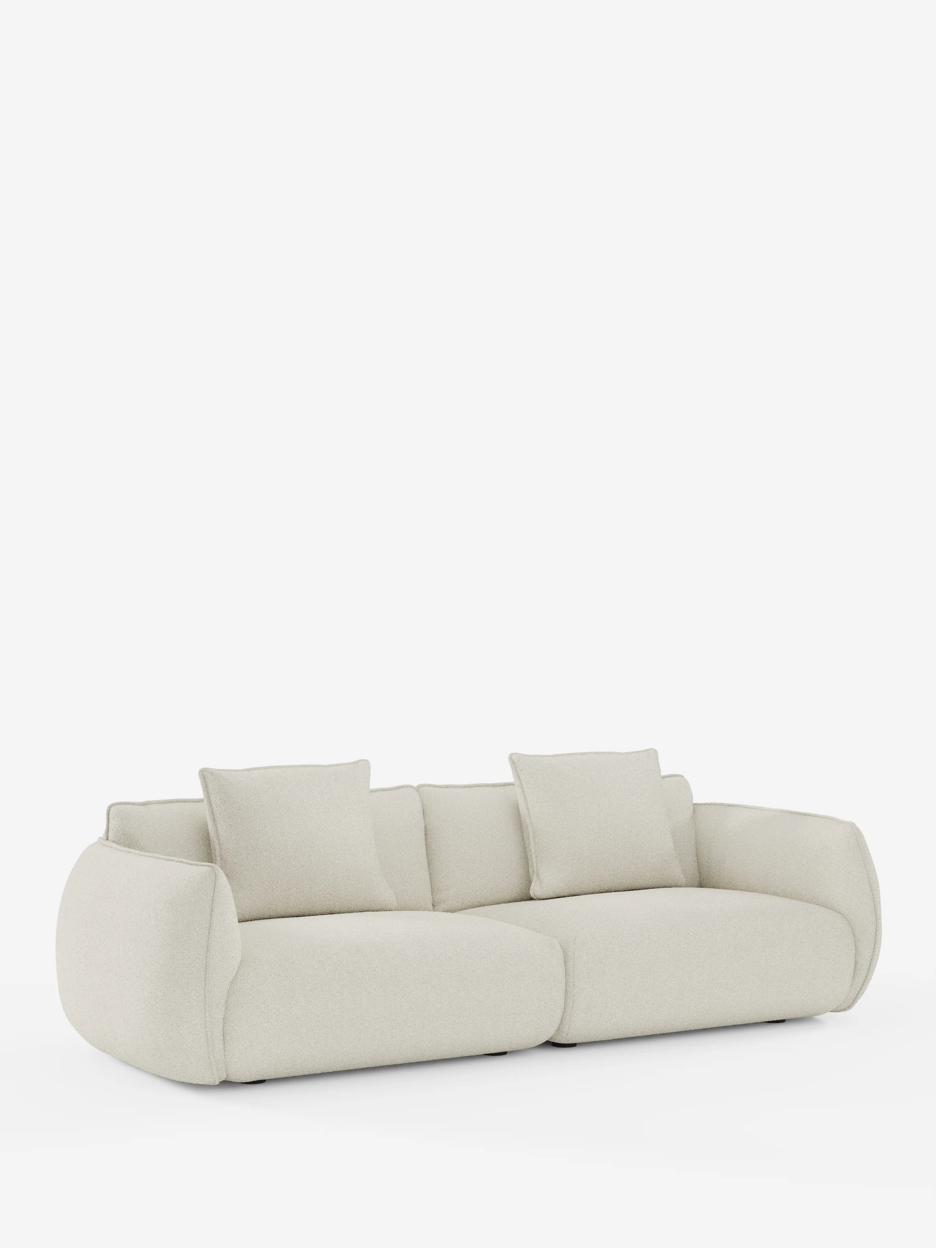 Un moderno e lussuoso divano modulare e componibile a 3 posti Nimbus da 250 cm di Divani.Store, rivestito in tessuto sfoderabile e antimacchia effetto cotone (t33) color bianco sporco, con bordi arrotondati e due cuscini quadrati coordinati, si staglia su uno sfondo bianco a tinta unita. Il divano presenta un profilo basso e sedute profonde e imbottite che gli conferiscono un aspetto accogliente e invitante.