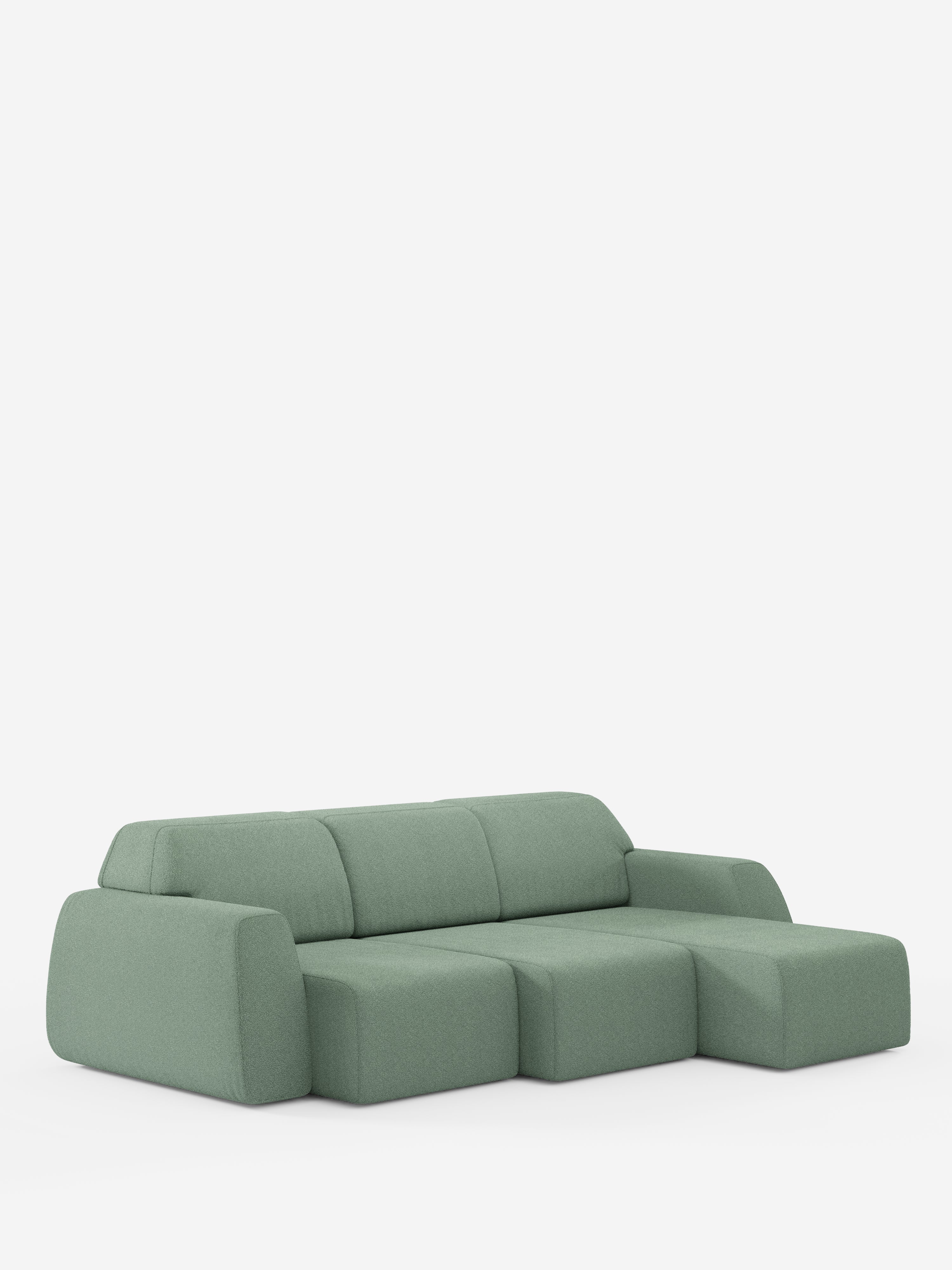 Un divano angolare Orbit moderno e minimalista in verde salvia di Divani.Store, caratterizzato da una chaise longue reversibile (penisola), tre cuscini di seduta, schienali bassi e ampi braccioli. Su uno sfondo bianco a tinta unita, questo divano presenta bordi morbidi e arrotondati e sedute completamente estensibili in tessuto T33 effetto cotone antimacchia.
