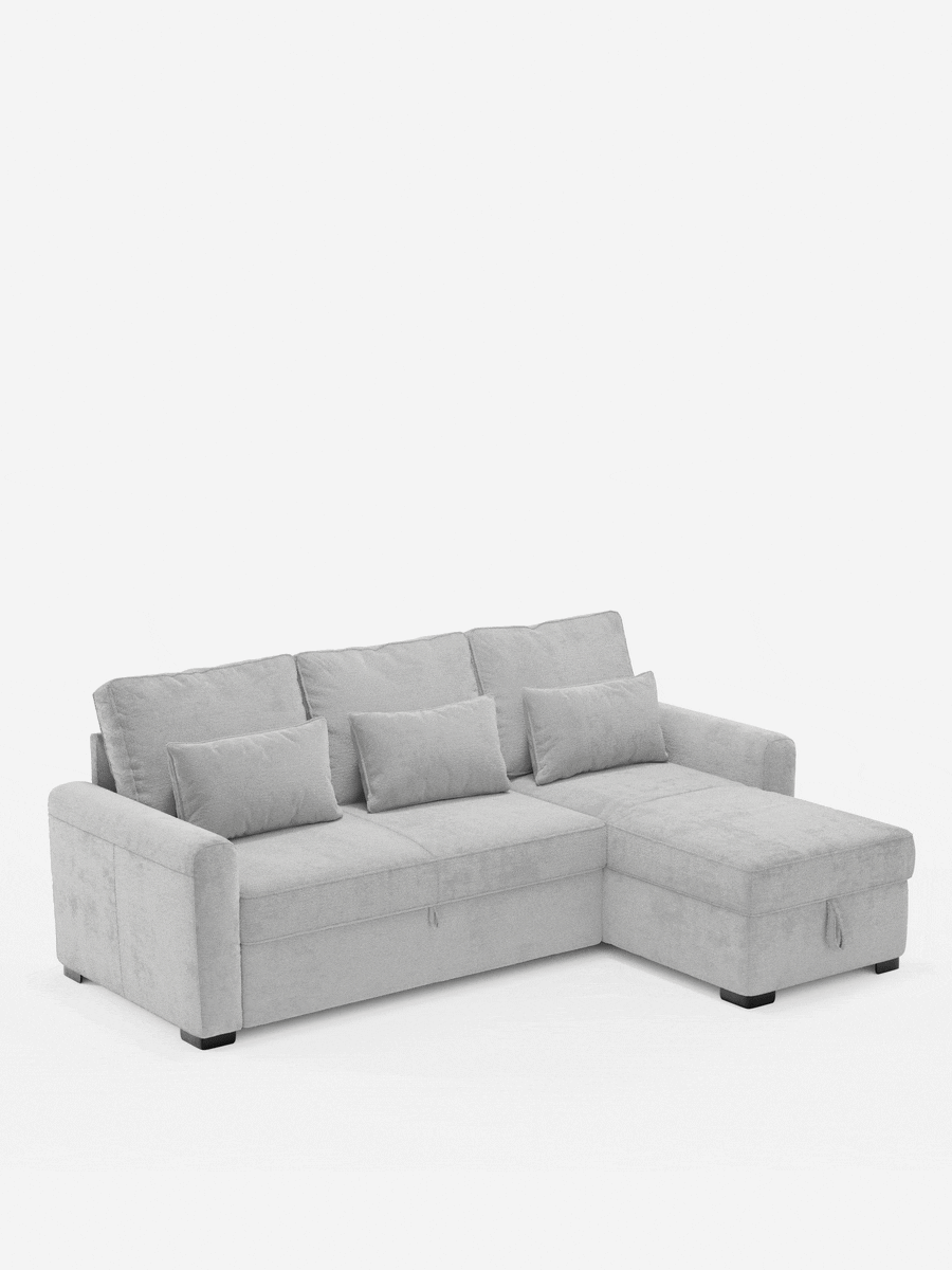 Ottaviano, divano letto con letto estraibile - penisola reversibile e contenitore in tessuto materico smacchiabile: un divano componibile grigio chiaro con chaise longue reversibile, contenitore, tre cuscini dello schienale e tre cuscini decorativi, su piedini bassi scuri.