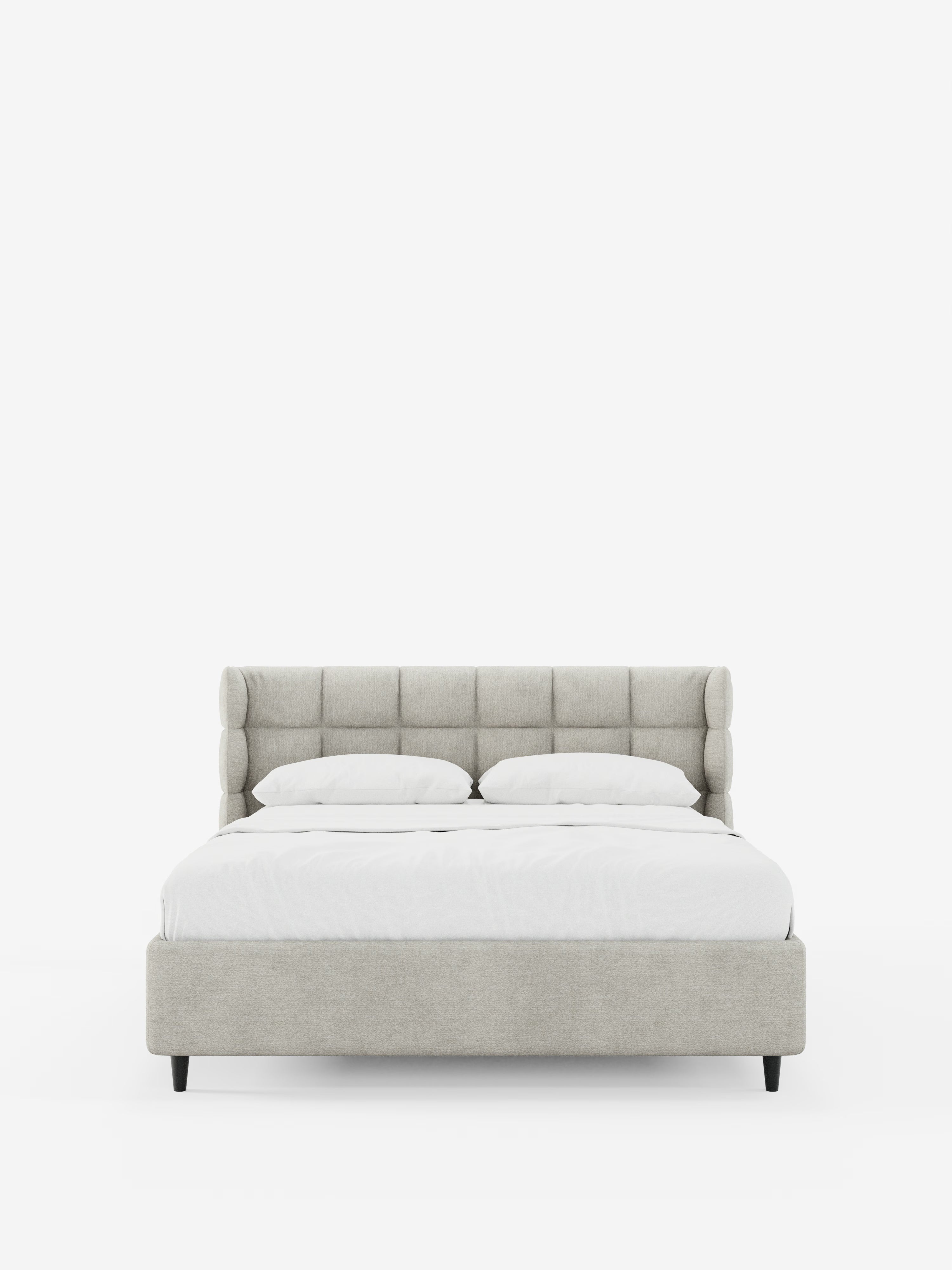 Il letto imbottito RAGNAR con contenitore e testiera capitonné avvolgente di Letti.store è presentato in tessuto beige certificato Oeko-Tex®, caratterizzato da un'alta testiera avvolgente con eleganti dettagli capitonné, una struttura a profilo ribassato con gambe nere e biancheria da letto di un bianco brillante. Due cuscini disposti con cura ne accentuano l’aspetto, mentre il letto spicca al centro di uno sfondo bianco a tinta unita.