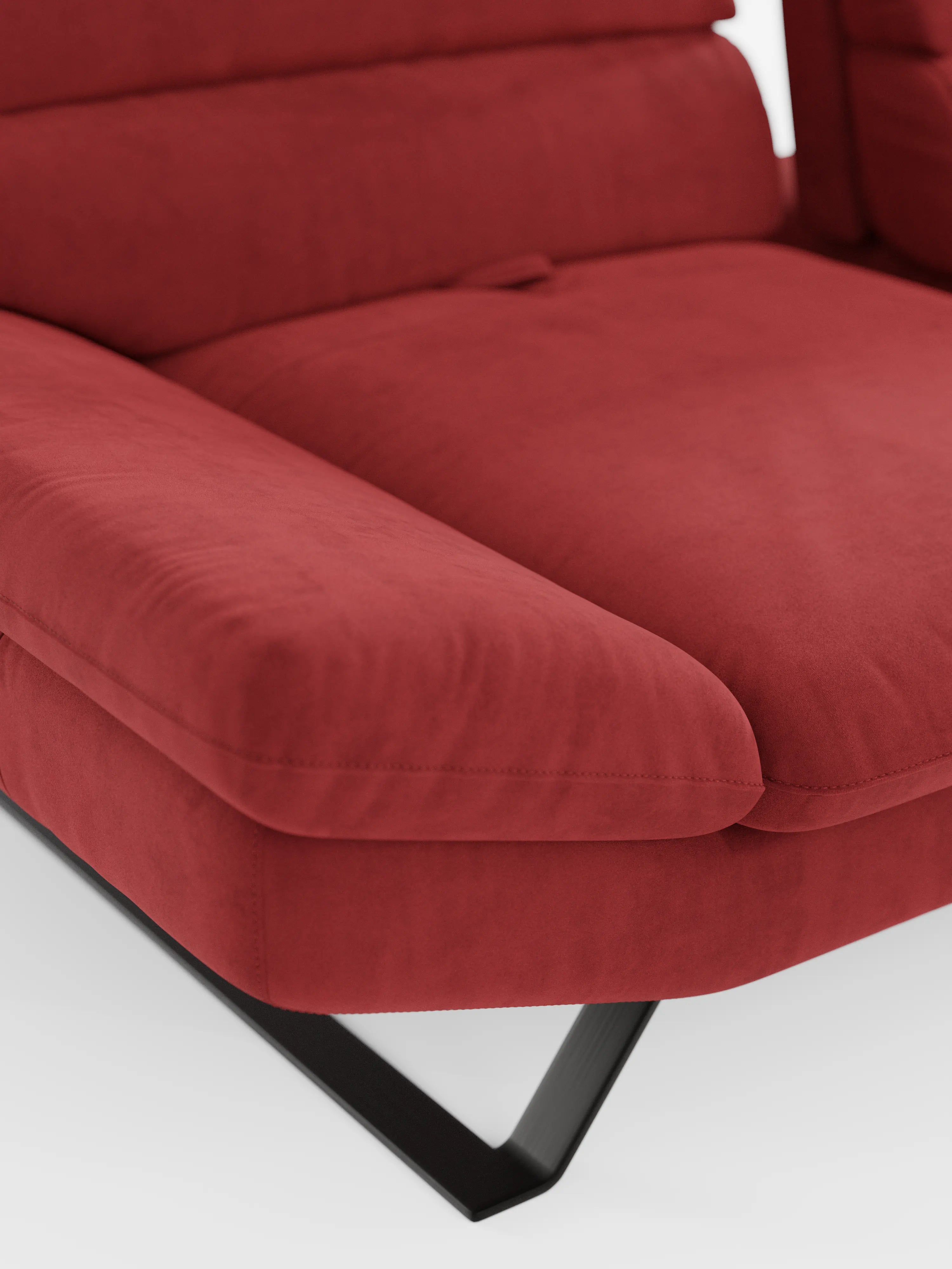 Primo piano del divano angolare Eclipse con penisola e schienali traslanti in microfibra tecnica smacchiabile T11 di Divani.Store, che mette in risalto il suo rivestimento rosso morbido e testurizzato, gli ampi braccioli inclinati e la base con gambe in metallo nero su sfondo bianco. Il cuscino spesso e morbido esalta il comfort e lo stile moderno. Questo divano angolare presenta una silhouette elegante con elementi di design versatili, perfetti per qualsiasi ambiente.