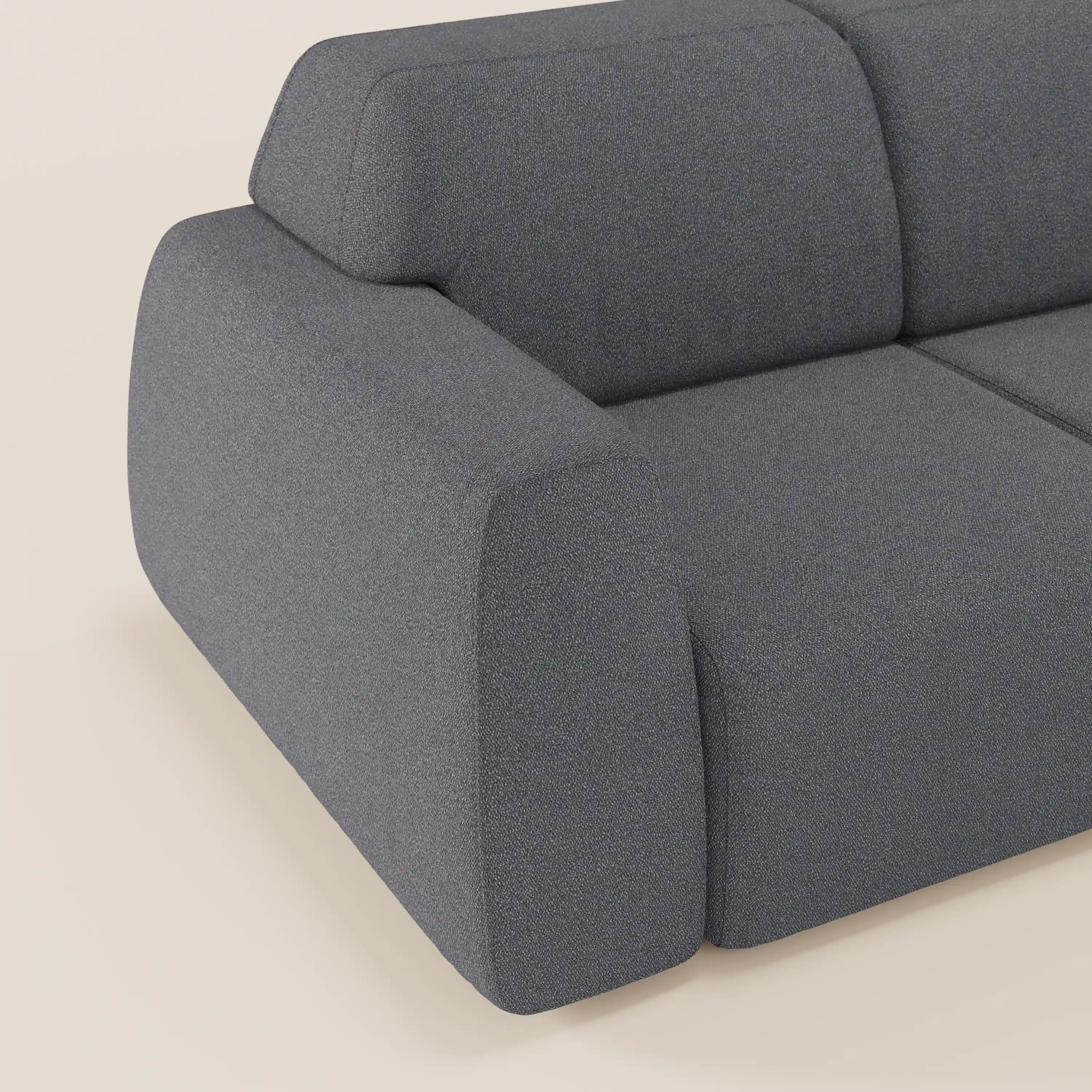Il divano Orbit con 3 sedute scorrevoli e allungabili in tessuto effetto cotone smacchiabile T33 di Divani.Store è presentato in parte su uno sfondo beige chiaro, che ne mette in risalto le linee moderne, lo spesso bracciolo e la morbida imbottitura grigia.