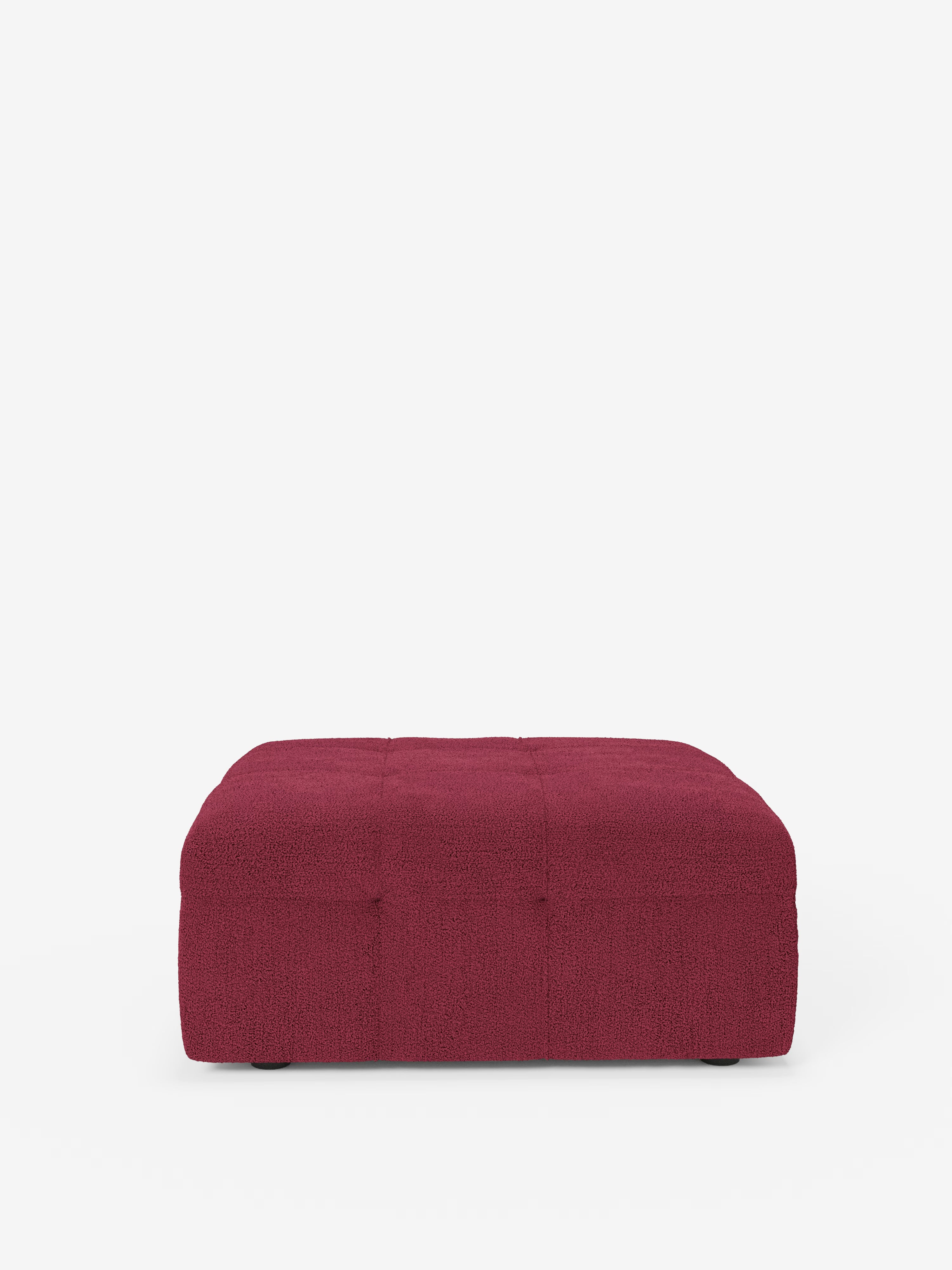 Un pouf Mosaic basso e rettangolare di Divani.Store, che misura 96x77 cm, è rivestito in bouclé rosso scuro antimacchia con motivo capitonné. Ritraatto di fronte all’altezza degli occhi su uno sfondo bianco, questo raffinato pezzo di produzione italiana presenta una superficie testurizzata e una delicata trapuntatura a quadrati, senza gambe visibili né elementi decorativi aggiuntivi.
