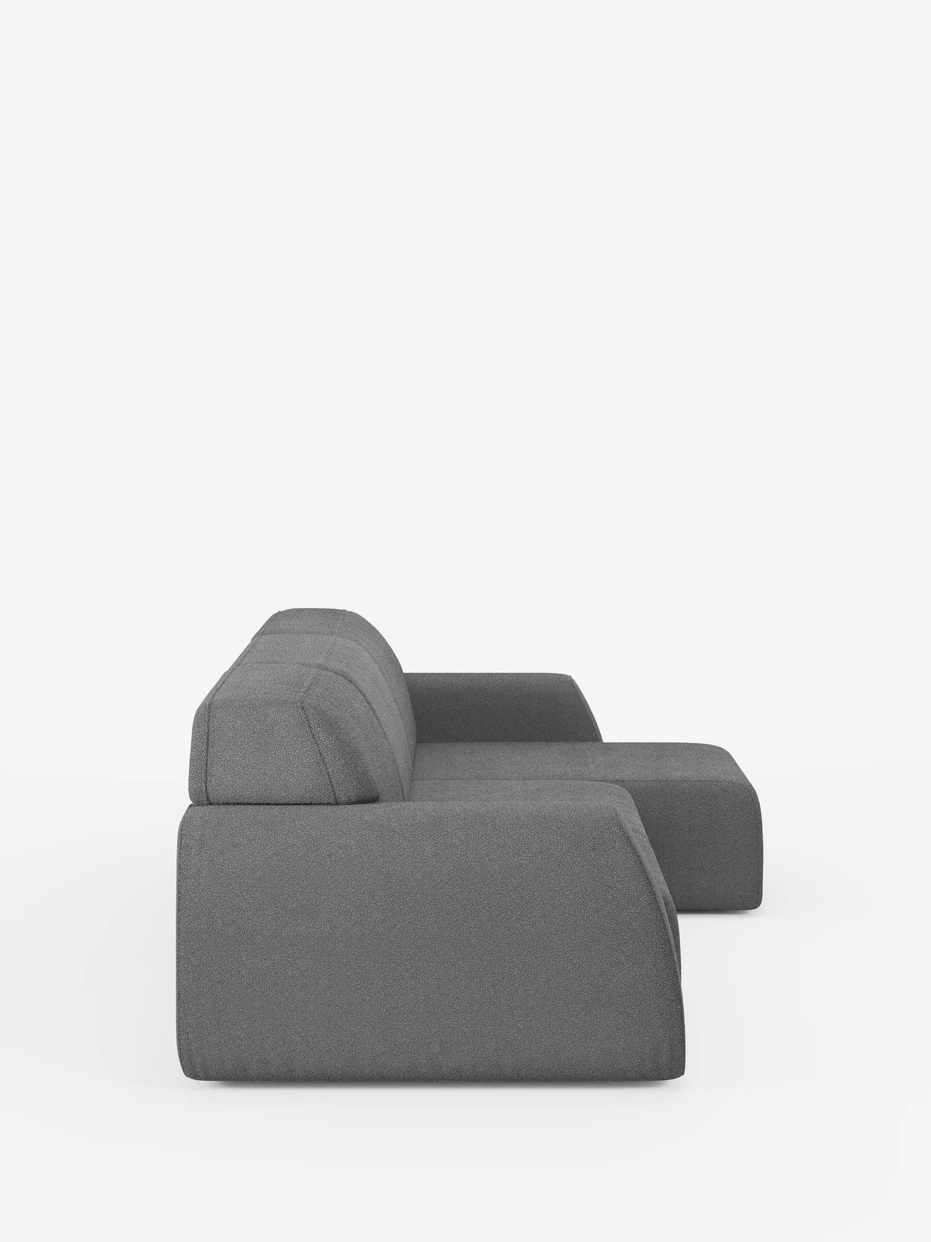 Un divano componibile grigio, elegante e moderno: l’Orbit Divano angolare con penisola reversibile e tutte le sedute allungabili in tessuto smacchiabile effetto cotone T33 di Divani.Store è raffigurato di profilo. Questo divano modulare vanta linee pulite, una silhouette slanciata e un unico bracciolo destro, il tutto su uno sfondo bianco a tinta unita: un connubio perfetto tra versatilità ed eleganza contemporanea.