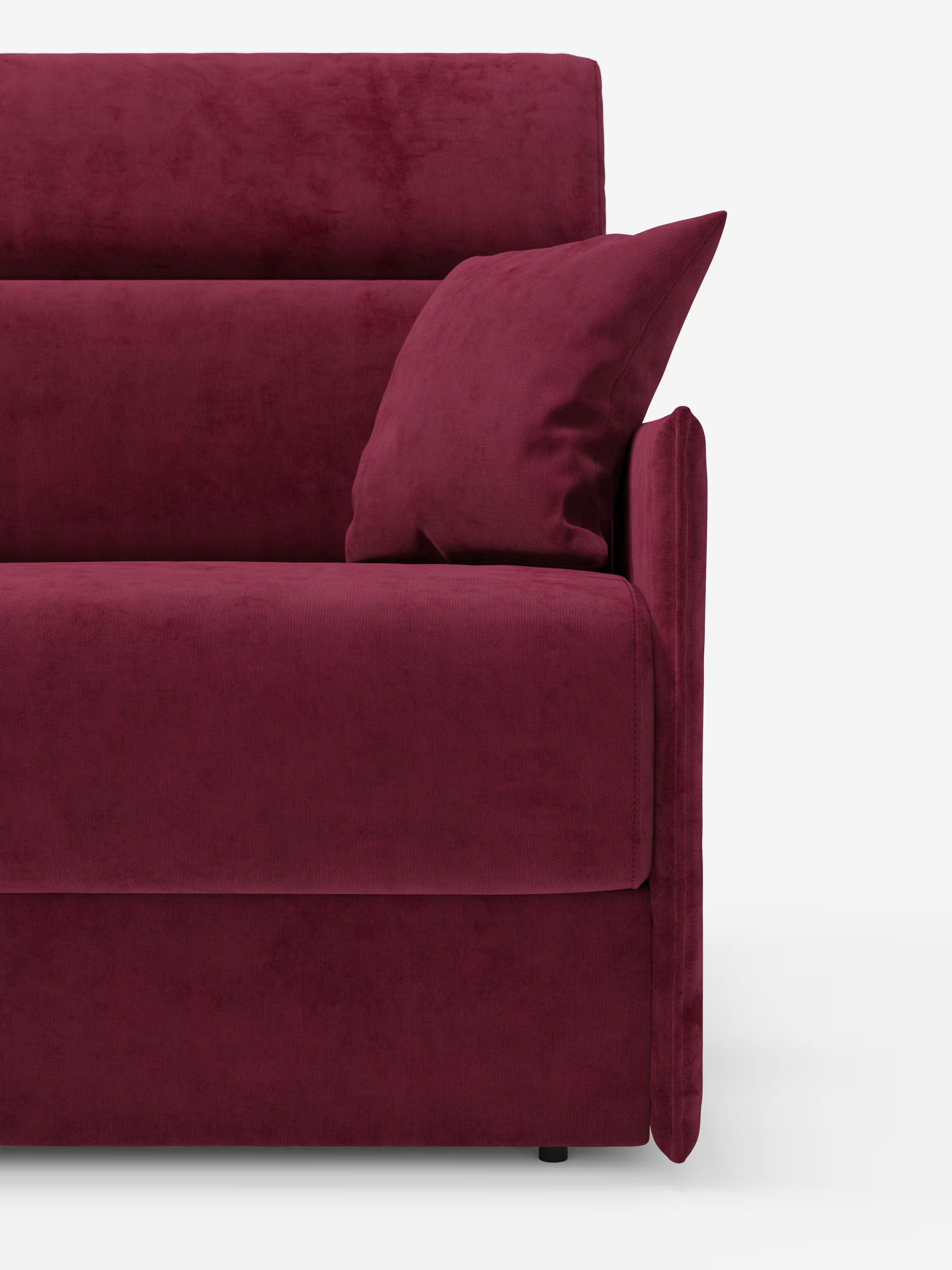 Un primo piano del divano letto Miryam con poggiatesta reclinabili e comfort maxi di Divani.Store, presentato in tessuto T31 smacchiabile color bordeaux scuro. L'immagine mette in risalto il bracciolo destro, una parte della seduta, il suo morbido schienale e un cuscino quadrato coordinato adagiato nell'angolo. Questo divano letto compatto presenta uno stile minimal contemporaneo ed è ripreso su uno sfondo bianco.