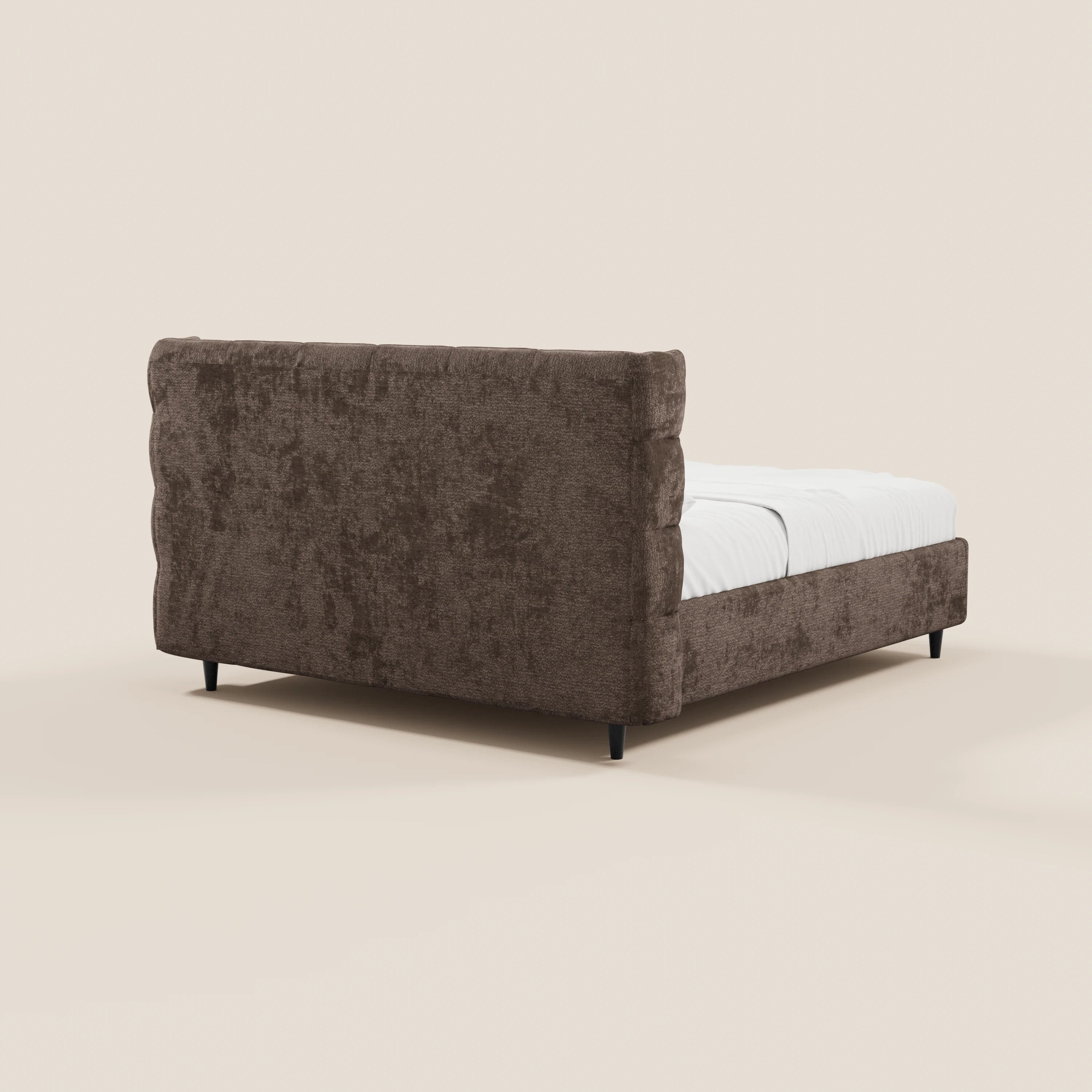 Il letto imbottito RAGNAR con contenitore e testiera capitonné avvolgente di Letti.store, rivestito in un elegante tessuto certificato Oeko-Tex®, presenta una struttura marrone con gambe nere corte e biancheria da letto bianca, su uno sfondo beige chiaro.