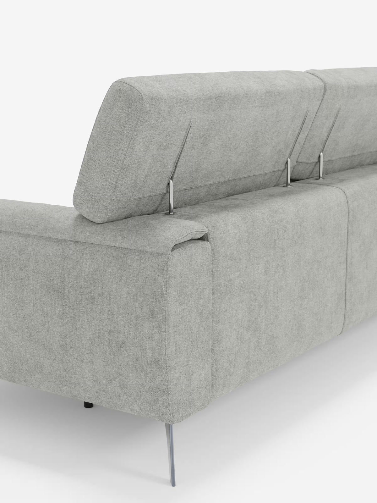 Visto da dietro, il divano Caravaggio a 4 posti con tre sedute scorrevoli di Divani.Store presenta un tessuto grigio chiaro resistente alle macchie (rivestimento T31), sottili gambe in metallo e poggiatesta imbottiti regolabili per un comfort personalizzabile. Questo divano moderno offre tre sedute scorrevoli e sfoggia linee pulite per un look elegante e contemporaneo, rendendolo la scelta perfetta per qualsiasi soggiorno. Ideale come spazioso divano a 4 posti, le sue generose sedute offrono un relax