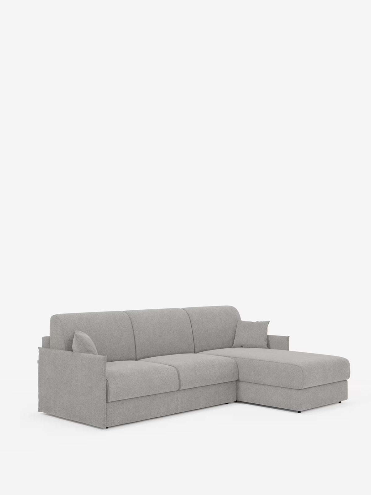 Il divano letto angolare con penisola contenitore Evans di Divani.Store è un divano componibile moderno, di colore grigio chiaro, dalle linee pulite e dal design compatto, rivestito in tessuto T23 facile da pulire. È dotato di una pratica penisola contenitore sul lato destro che offre spazio aggiuntivo, di schienale e braccioli bassi e squadrati e di gambe corte e quasi invisibili. Il divano è ripreso su uno sfondo bianco a tinta unita.