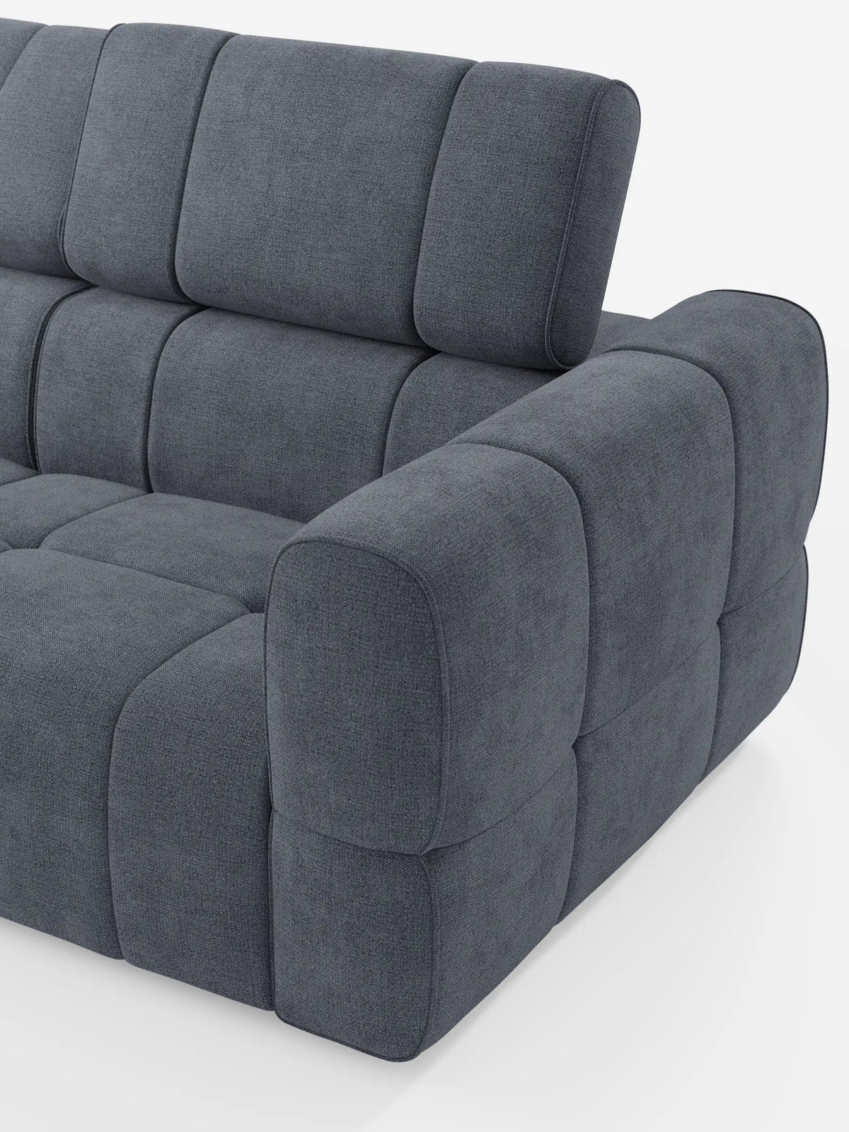 Il divano componibile Giotto, color grigio antracite, con terminale aperto – opzione relax elettrico in tessuto smacchiabile T23 – presenta una trama trapuntata con cuciture quadrate, braccioli arrotondati e un poggiatesta inclinato verso l’alto su uno sfondo bianco.