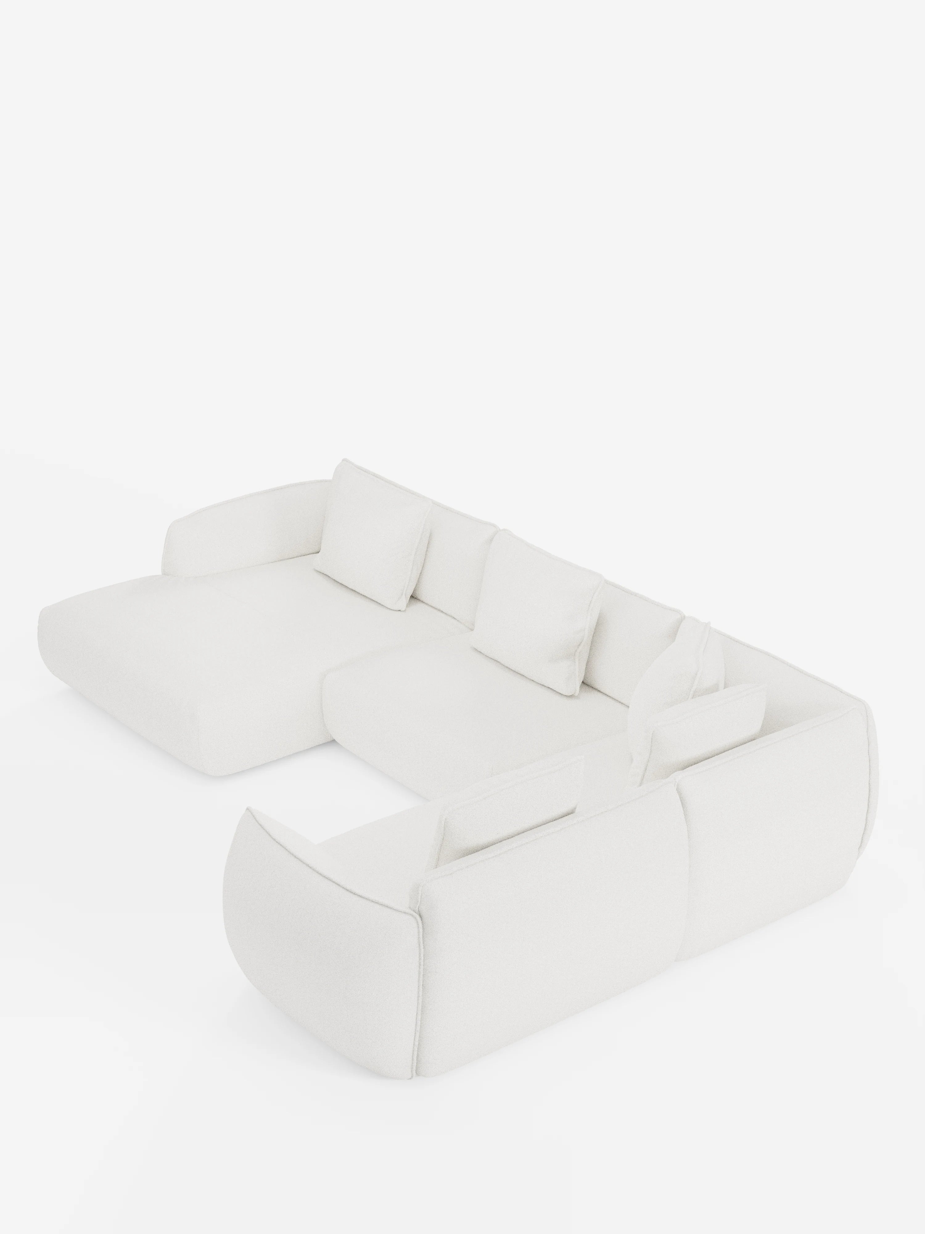 Il divano angolare panoramico componibile Nimbus con penisola e angolo in tessuto smacchiabile T33 di Divani.Store è un moderno divano componibile a L di colore bianco sporco, caratterizzato da braccioli e schienali bassi e arrotondati. Comprende tre cuscini di seduta e quattro cuscini schienali rettangolari, e poggia direttamente sul pavimento senza gambe a vista, per un look minimalista e accogliente.