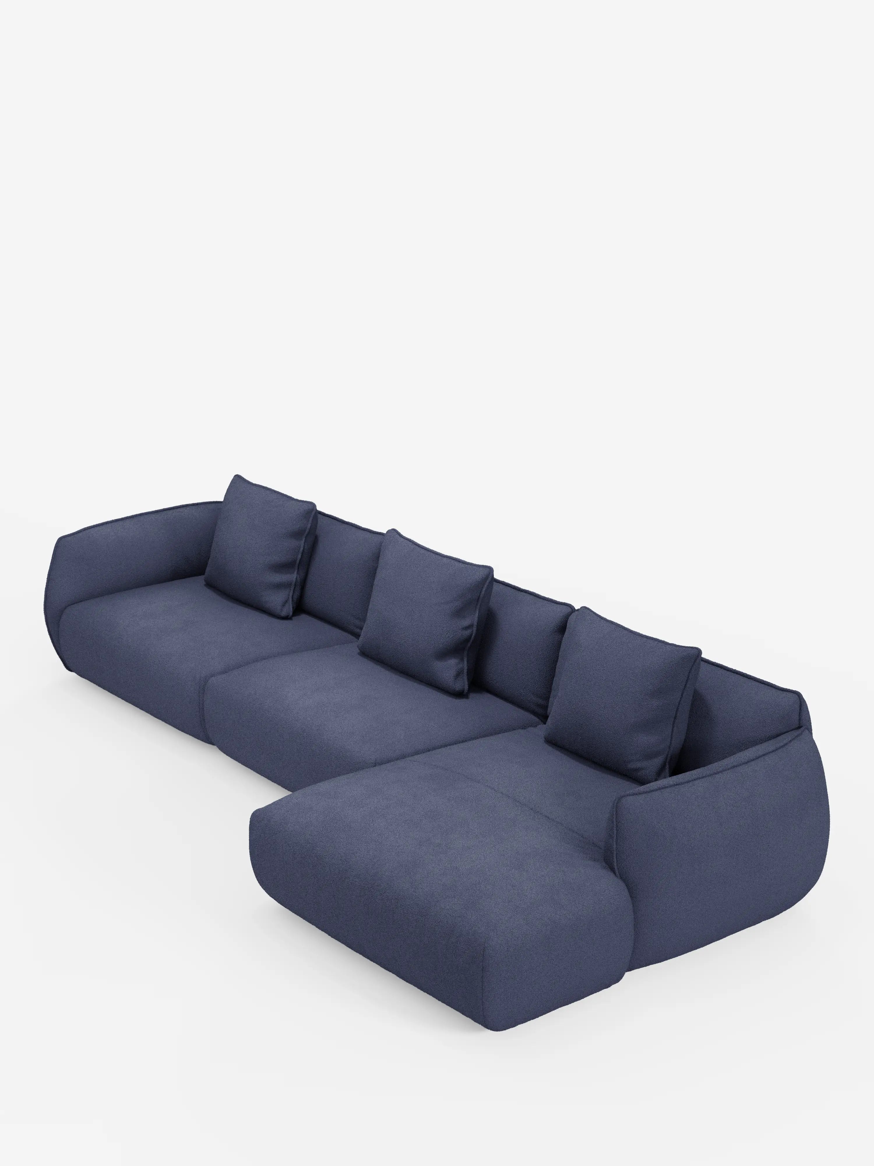 Un divano angolare contemporaneo Nimbus con penisola componibile di Divani.Store, rivestito in morbido tessuto T33 effetto cotone, resistente alle macchie, in blu scuro, con quattro cuscini dello schienale, una chaise longue estesa sul lato destro e bordi arrotondati che ne definiscono l’estetica moderna e minimalista, il tutto su uno sfondo bianco a tinta unita.