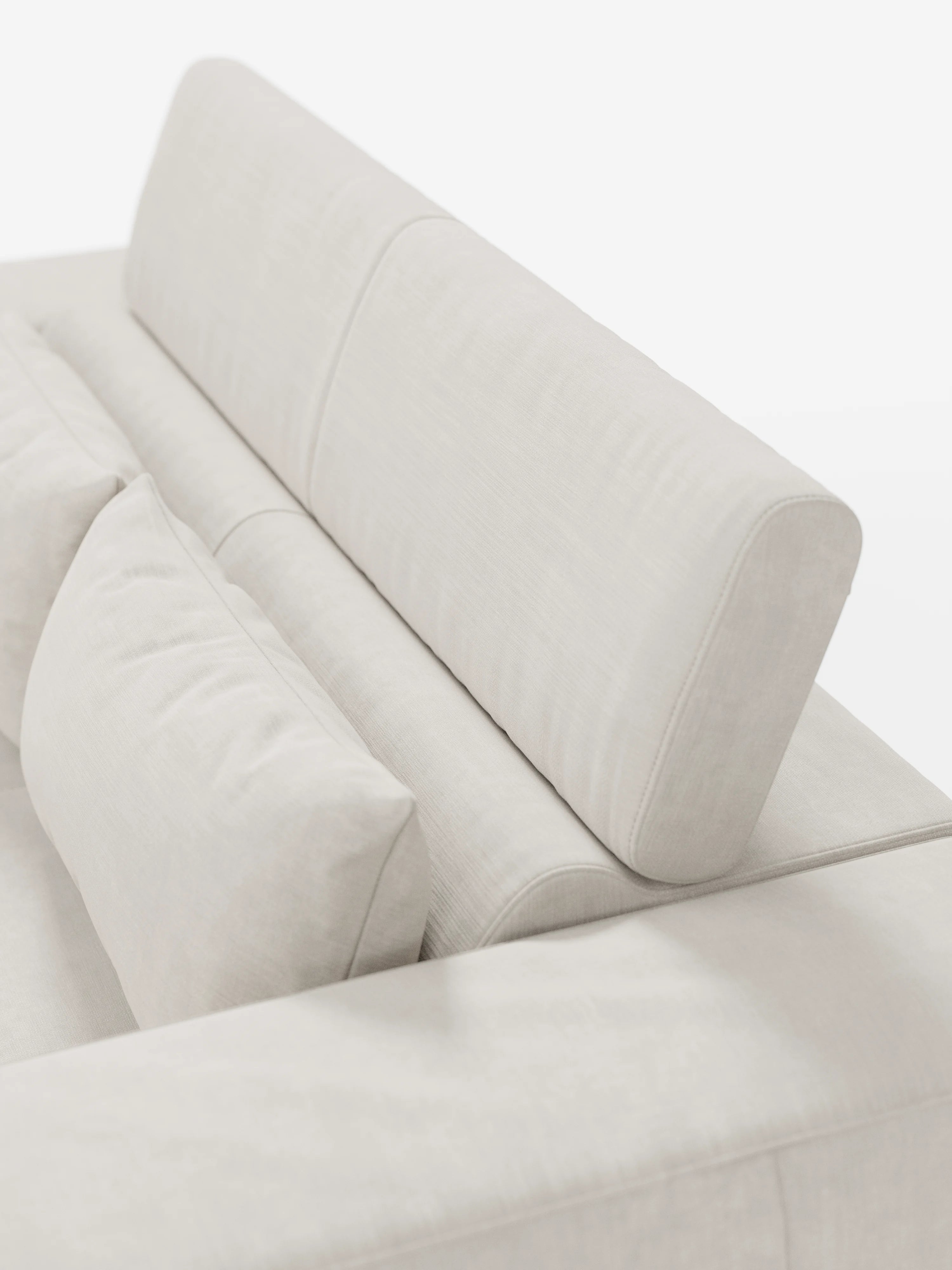 Un primo piano del divano Monarch con funzione relax elettrica per l’allungamento delle sedute e poggiatesta reclinabile di Divani.Store, che mette in risalto il suo rivestimento in tessuto T31, morbido e resistente alle macchie, in beige chiaro. L'immagine mette in risalto lo schienale imbottito e il cuscino lombare abbinato, caratterizzati da linee pulite e da un design minimalista e contemporaneo. Lo sfondo è bianco a tinta unita.