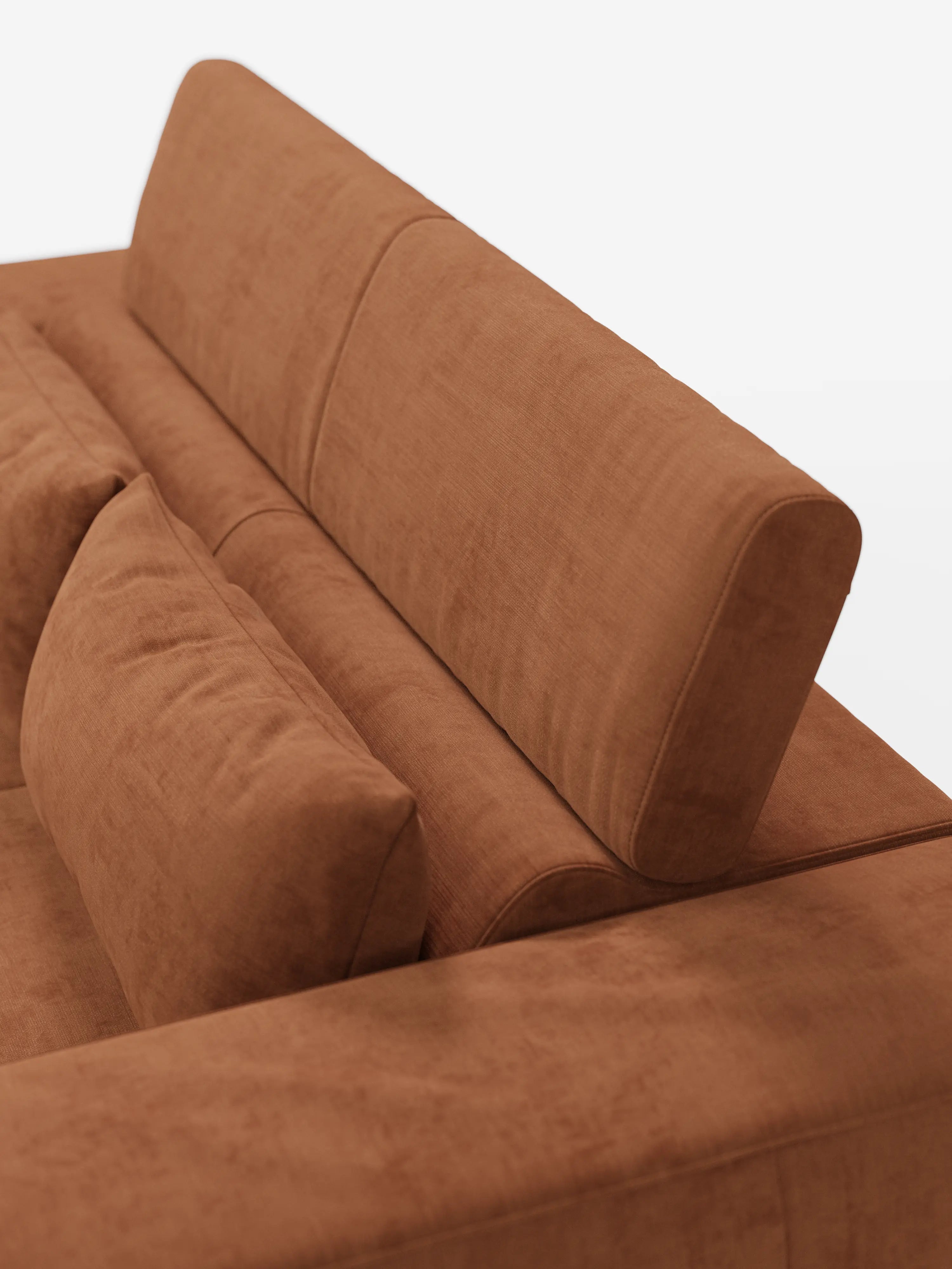 Un primo piano del divano Monarch con funzione relax elettrica di Divani.Store, rivestito in morbido tessuto T31 antimacchia in una moderna tonalità di marrone. Il divano è dotato di un sistema di estensione elettrica della seduta e di un poggiatesta reclinabile, abbinato a un cuscino coordinato. La sua trama simile alla pelle scamosciata e le linee pulite risaltano sullo sfondo bianco, mettendo in risalto il design minimalista e contemporaneo.