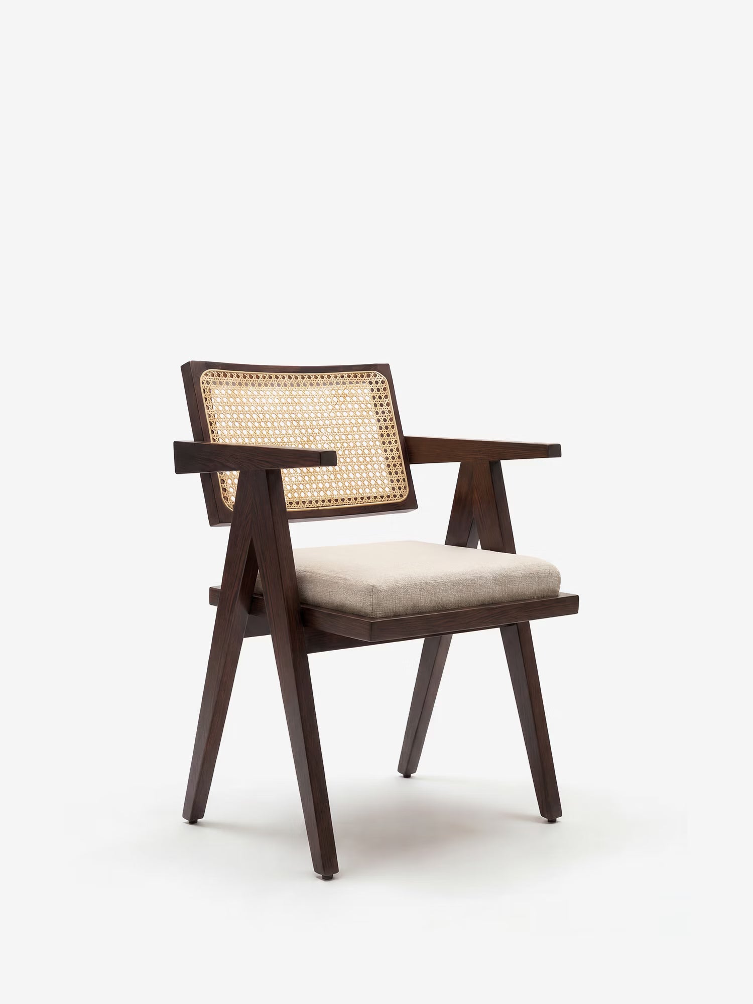 La sedia Antea di Divani.Store è realizzata in legno massello di wengé con braccioli, schienale in rattan e seduta imbottita in misto cotone, per un look in stile mid-century. La sua finitura scura e liscia risalta sullo sfondo bianco.