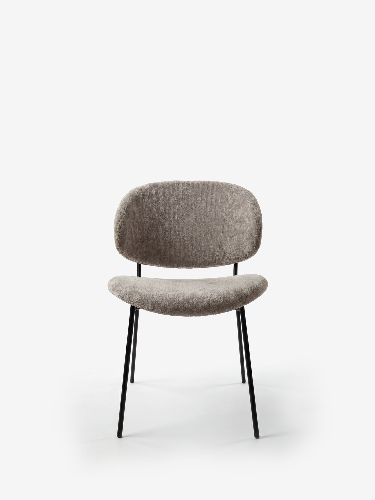 La sedia Bruma di Divani.Store è caratterizzata da un elegante tessuto goffrato, gambe in metallo nero, un design minimalista e uno schienale avvolgente, perfetta per gli spazi contemporanei.