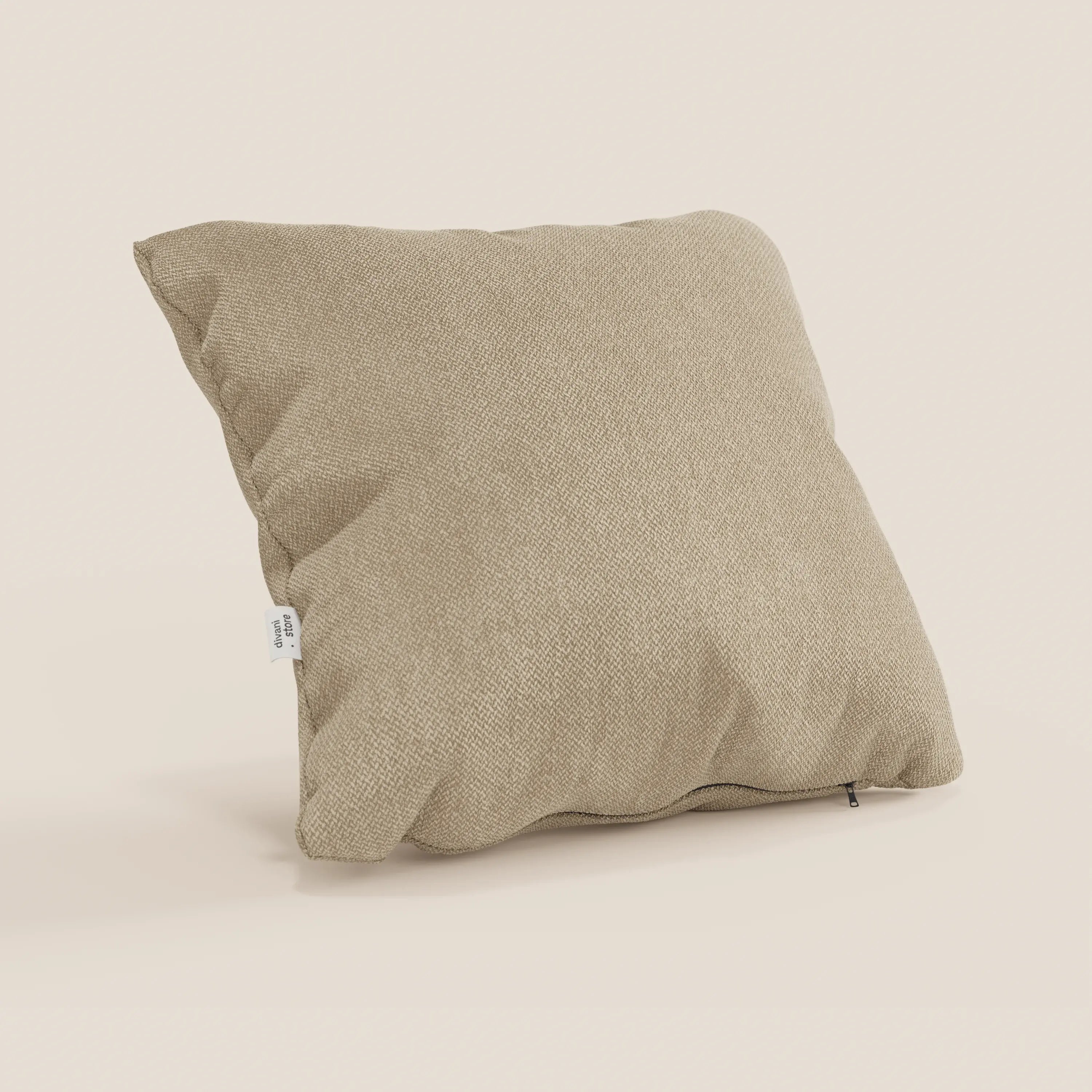 Il cuscino Sogno di Divani.Store in tessuto morbido smacchiabile T05 cammello si erge su uno sfondo chiaro, con etichetta bianca e cerniera a vista, perfetto come elegante cuscino per divano dall'aspetto rilassato e morbido.