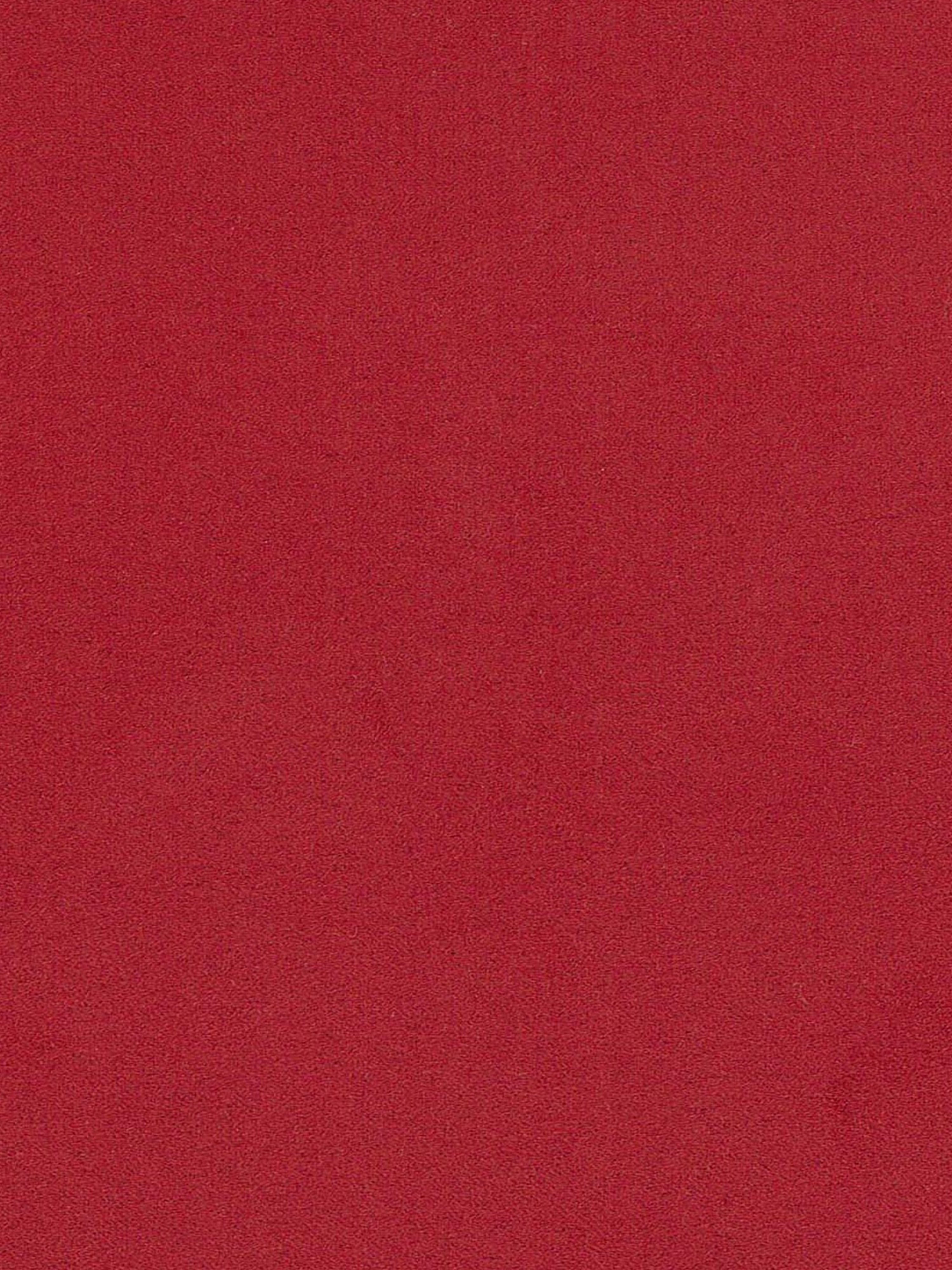 Un primo piano di una superficie rossa con texture, probabilmente il rivestimento in microfibra tecnica smacchiabile T11 del divano angolare con penisola e schienali traslanti “Eclipse” di Divani.Store. Il colore è uniforme con sottili sfumature, che creano un aspetto morbido e vellutato che ricorda un rivestimento lussuoso e facile da pulire. Non sono visibili motivi, oggetti o segni distintivi.