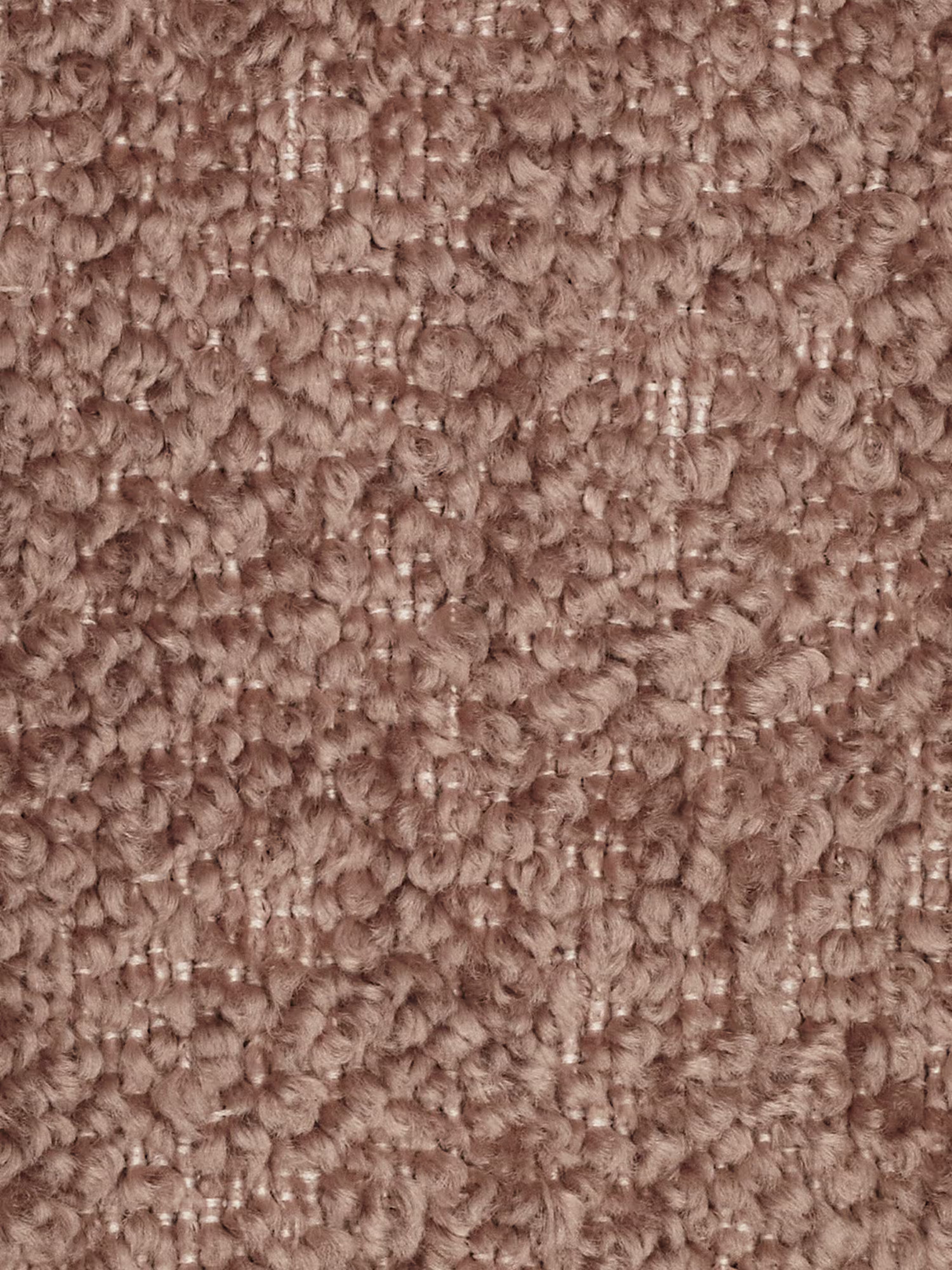 Primo piano di un tappeto a pelo riccio testurizzato, in una tonalità tenue di rosa. I riccioli formano una superficie morbida e irregolare con un delicato motivo a griglia. La fibra appare soffice e ben intrecciata, mettendo in risalto la consistenza densa e avvolgente del tappeto: una base accogliente per qualsiasi divano modulare o divano moderno come elemento centrale dell’arredamento.