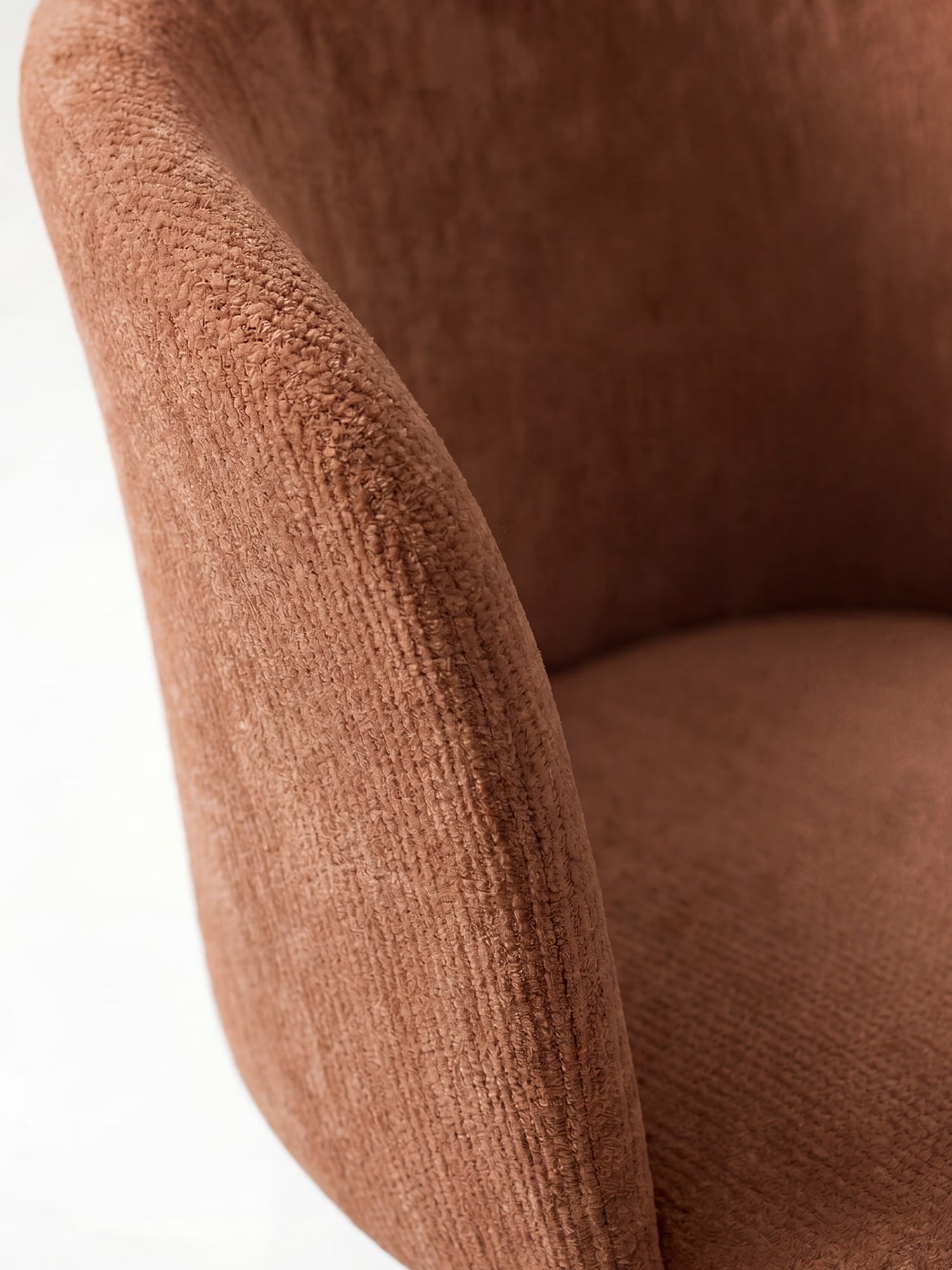 Primo piano della sedia moderna Talia di Divani.Store, rivestita in morbido tessuto ciniglia marrone chiaro certificato OEKO-TEX®. L'immagine mette in risalto la sua texture soffice e i braccioli arrotondati su uno sfondo bianco.