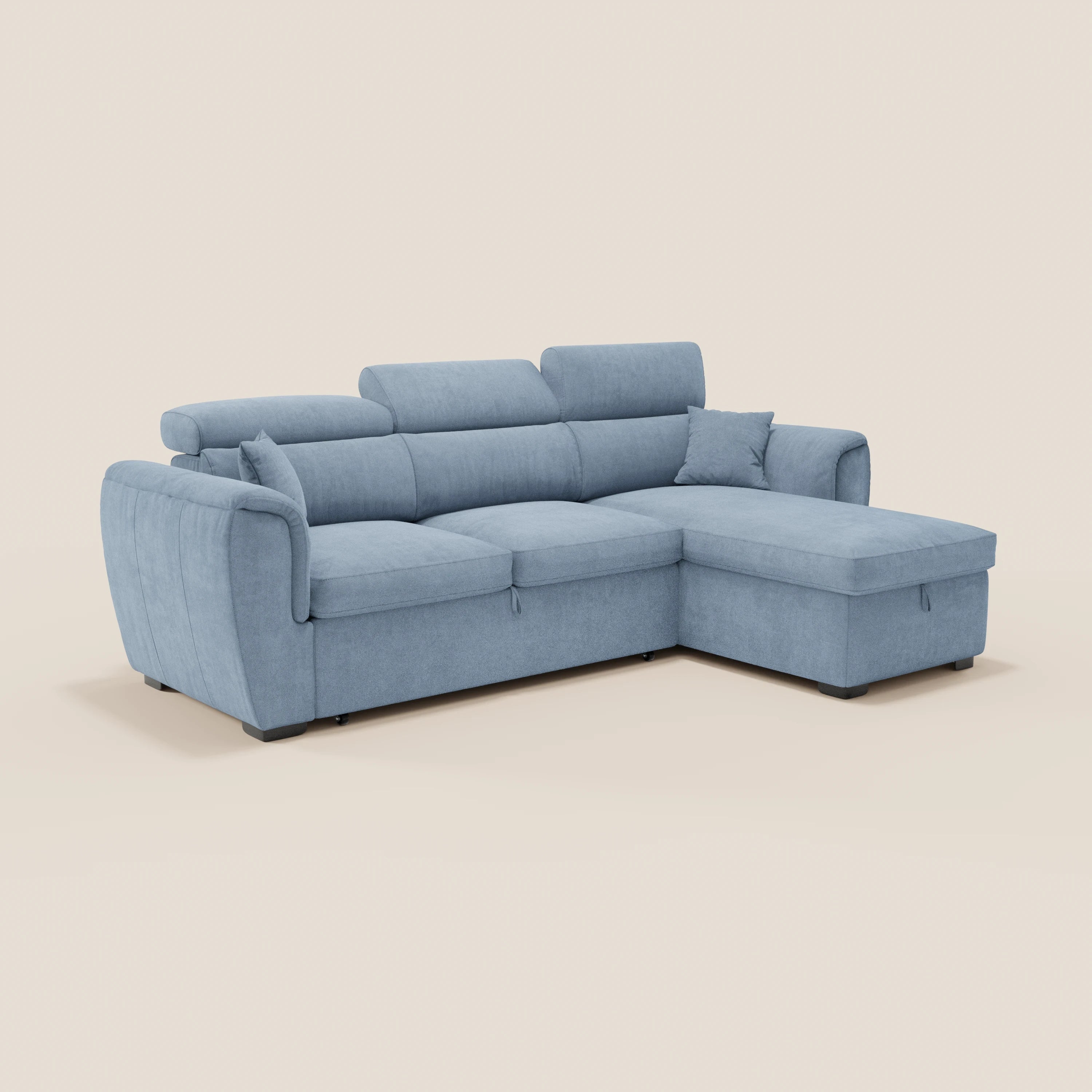 Il divano letto Titano di Divani.Store è dotato di una chaise longue reversibile con vano portaoggetti, poggiatesta reclinabili, un elemento estraibile e un tessuto antimacchia di colore azzurro, impreziosito da morbidi cuscini e braccioli laterali su uno sfondo beige.