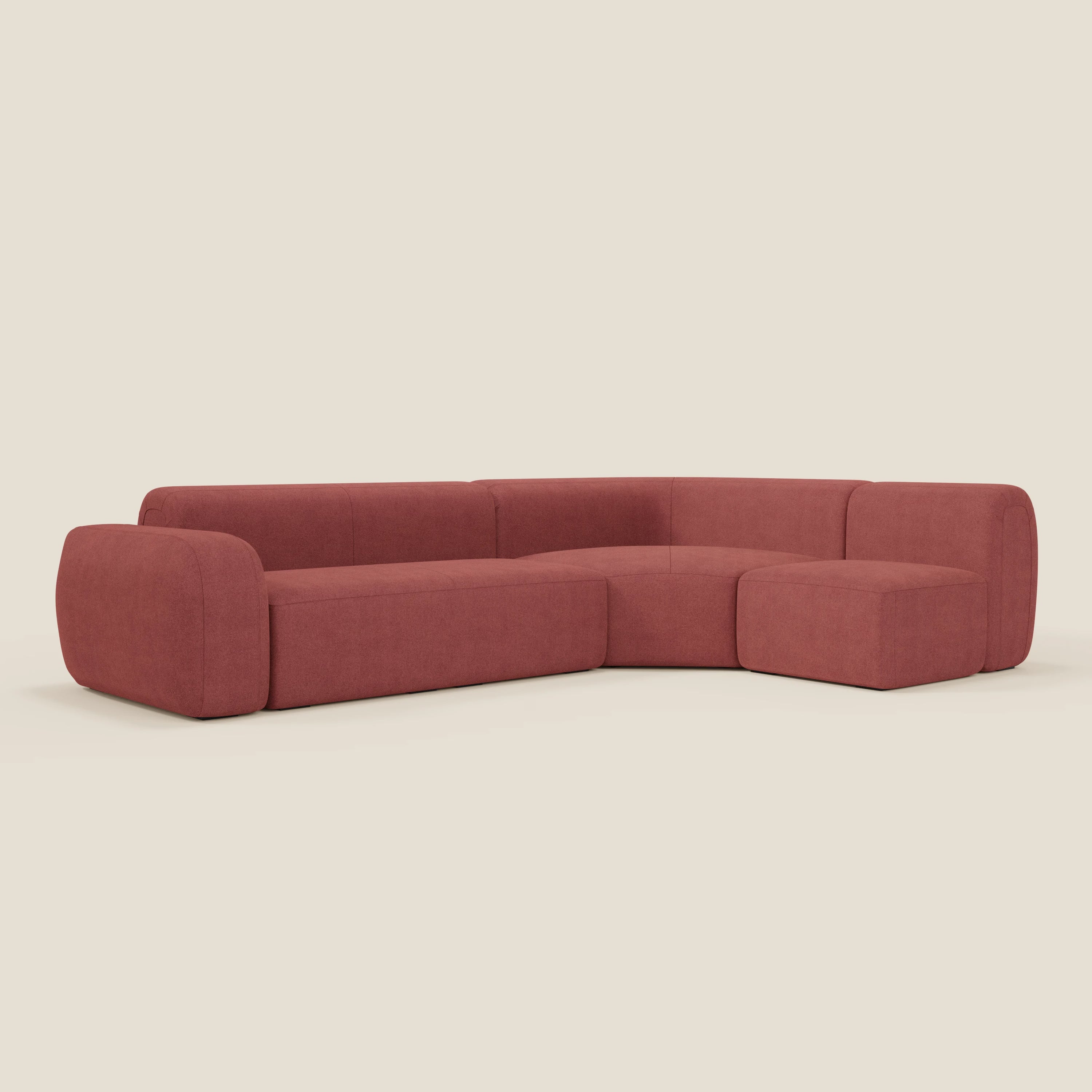Il divano BonBon angolare componibile e modulare di Divani.Store è rivestito in tessuto smacchiabile T23 rosso ciliegia, con una moderna forma a L, braccioli e bordi arrotondati, cuscini massicci e schienale basso.