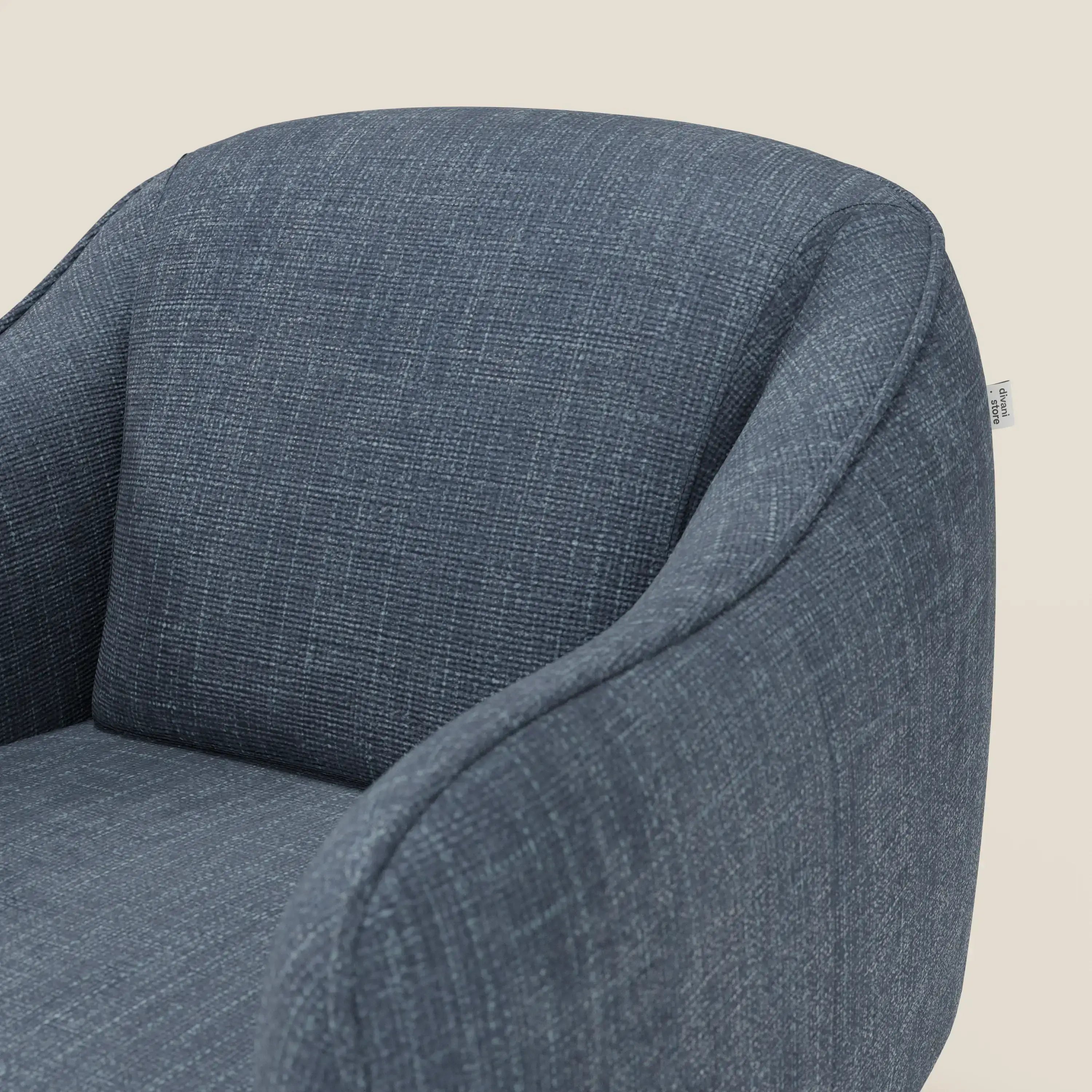 Avela Poltroncina di Divani.Store, presentata in morbido tessuto impermeabile blu T06, è caratterizzata da uno schienale arrotondato e braccioli curvi dalle linee eleganti e dal design minimalista su uno sfondo chiaro.