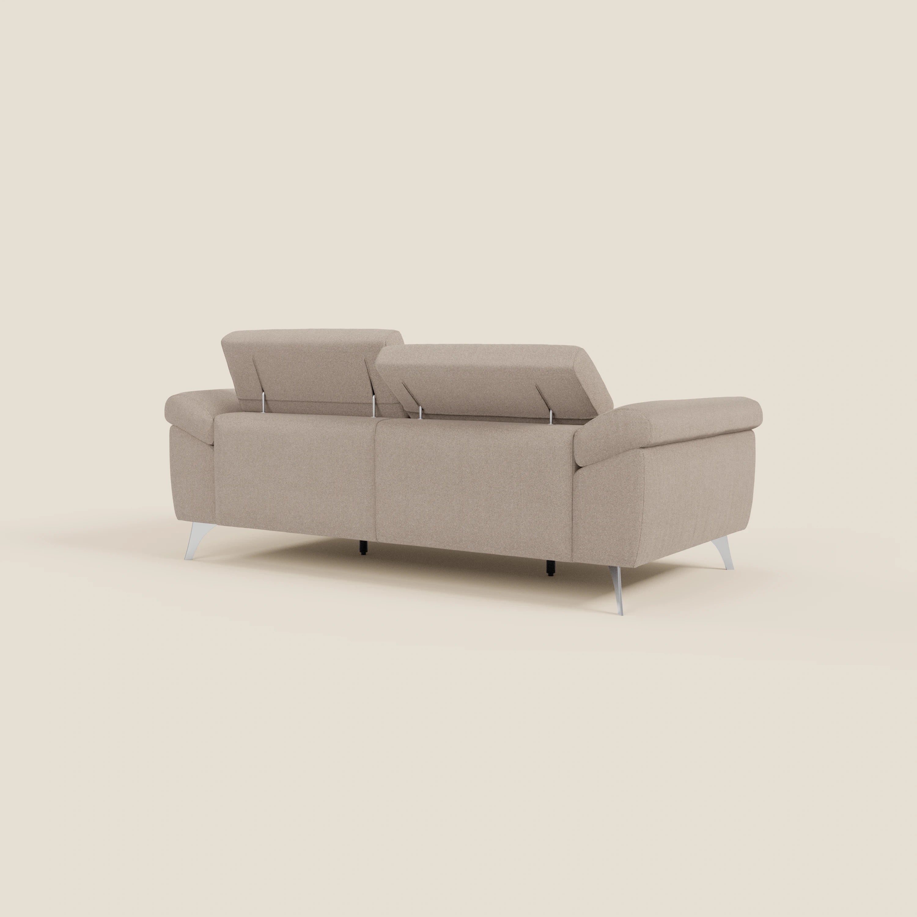 Il divano Donatello di Divani.Store, in tessuto antimacchia T23 color tortora, è caratterizzato da sedute allungabili, braccioli contenitori e poggiatesta reclinabili. Il suo design elegante risplende su uno sfondo minimalista color crema.