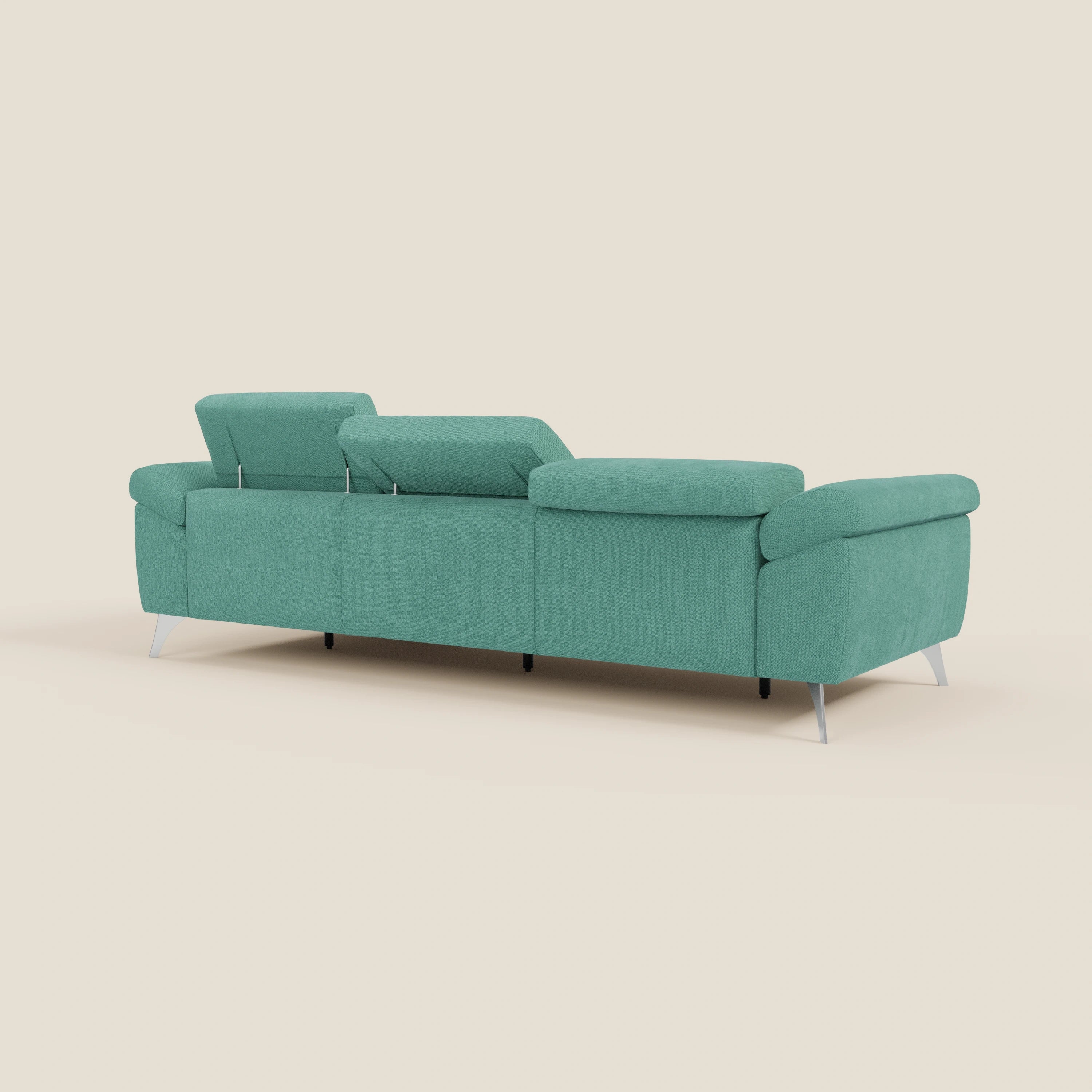 Il divano angolare Donatello di Divani.Store, in morbido tessuto antimacchia T23 verde acqua, ha sedute scorrevoli, braccioli contenitori e poggiatesta regolabili. Il suo design moderno e il suo comfort risaltano su uno sfondo beige semplice.